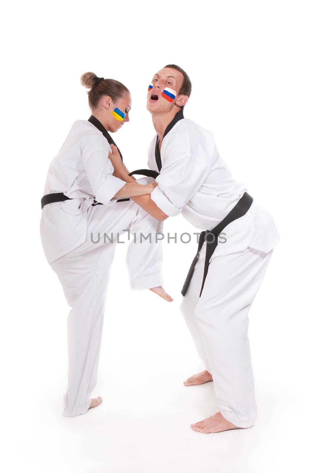 Ukraine representative make kick move on Russia, two fighting representatives of different countries. Woman make ankle kick to a man, two fighting people isolated on white background.