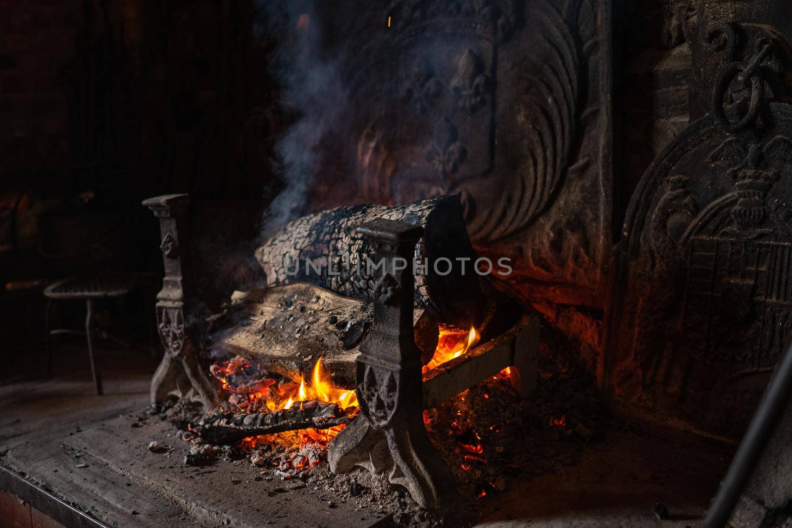 Fireplace and bonfire with firewood in an old French house