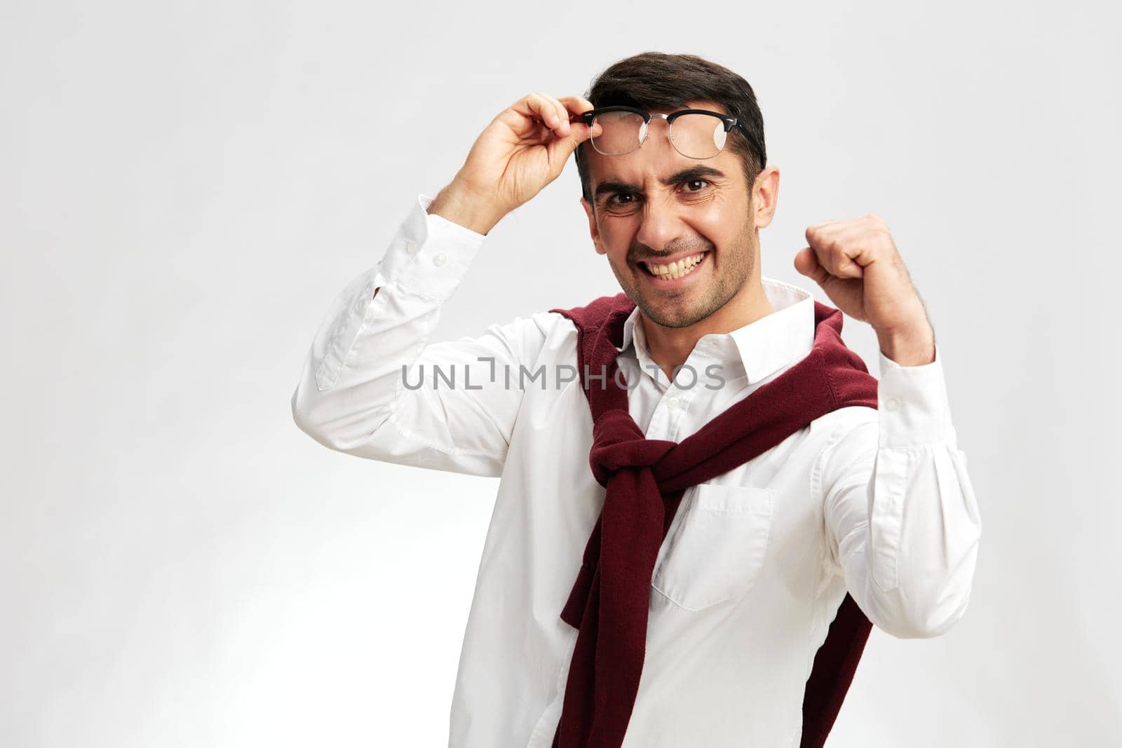 man in a white shirt sweater on the shoulders pensive look glasses isolated background by SHOTPRIME