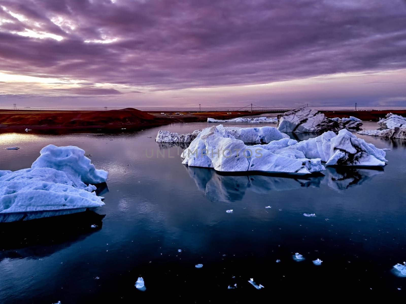 Aerial view of Glacier lagoon in Iceland during the sunrise. Ice floes calved from the glacier. melting ice