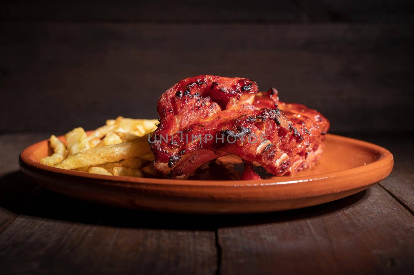 Tracking shot of delicious Grilled bbq ribs on stone plate. High quality photography.