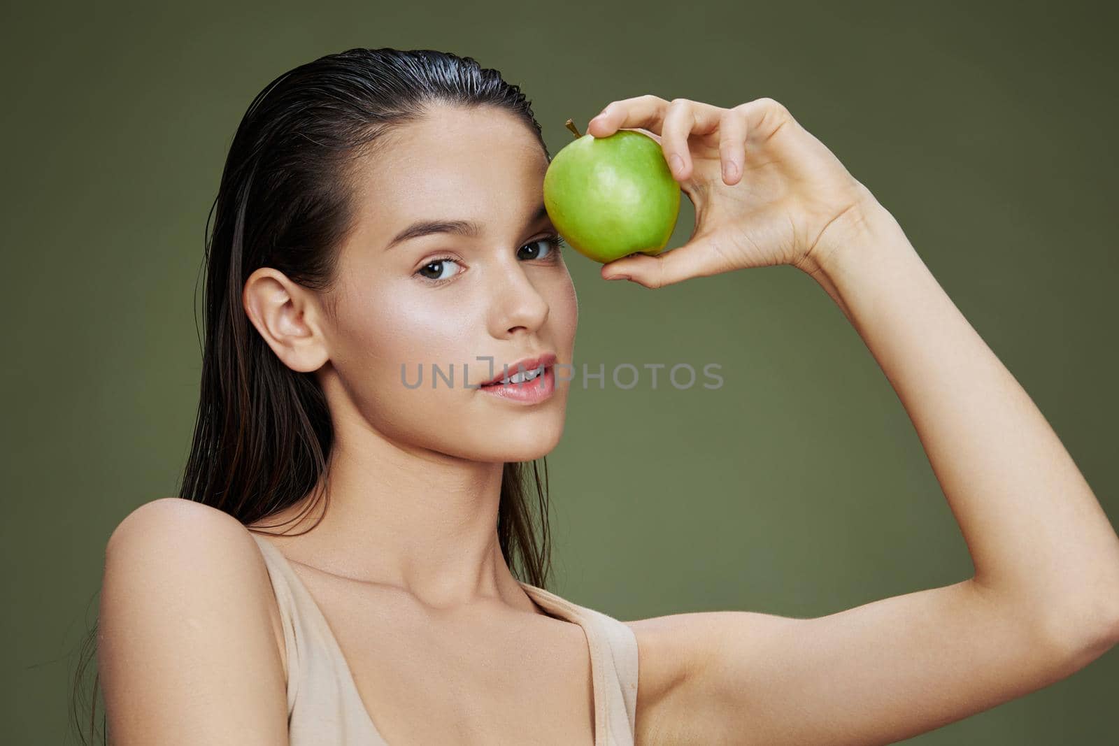 young woman apple in hands posing fruit healthy food fresh Green background by SHOTPRIME