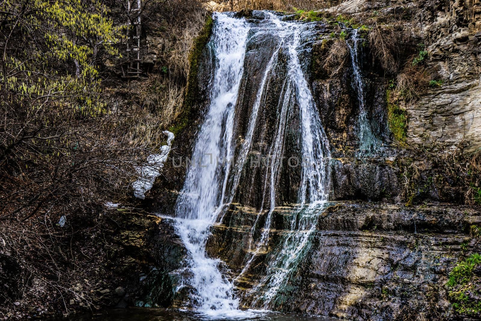 Waterfall in wild area close to georgian capital city Tbilisi in early sping season