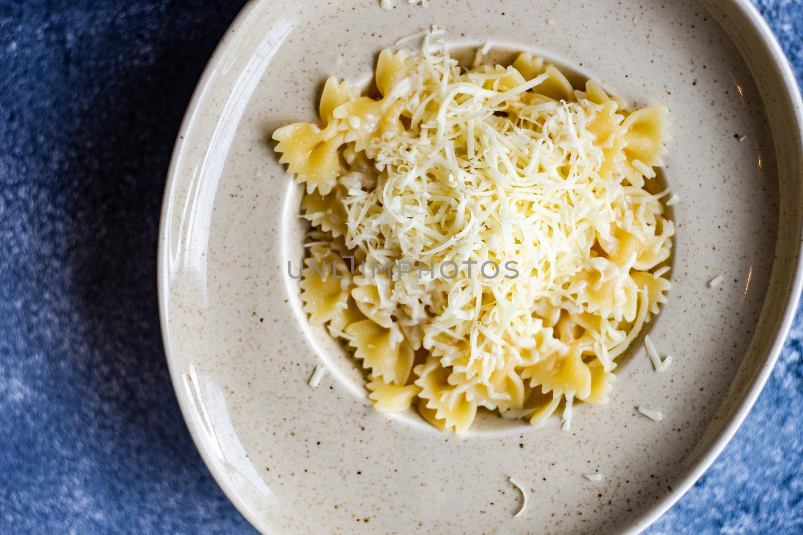 Close up of farfalle pasta with cheese served in a bowl