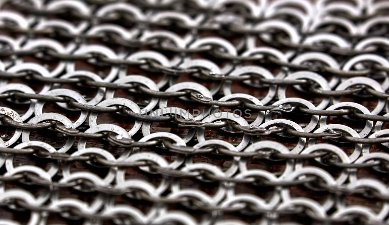 Chain-mail or Hauberk texture, metal protective armor of medieval or middle ages times. Hauberk medieval knight equipment shirt of ring mail