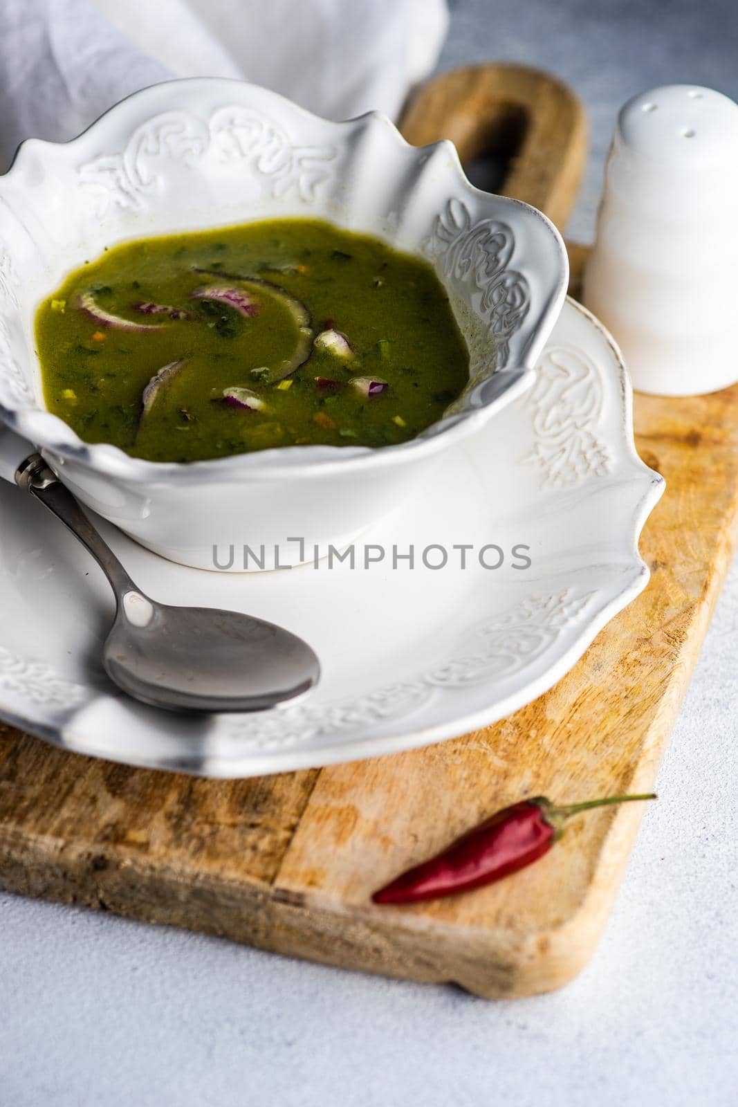Healthy spinach creamy soup served in a bowl on table