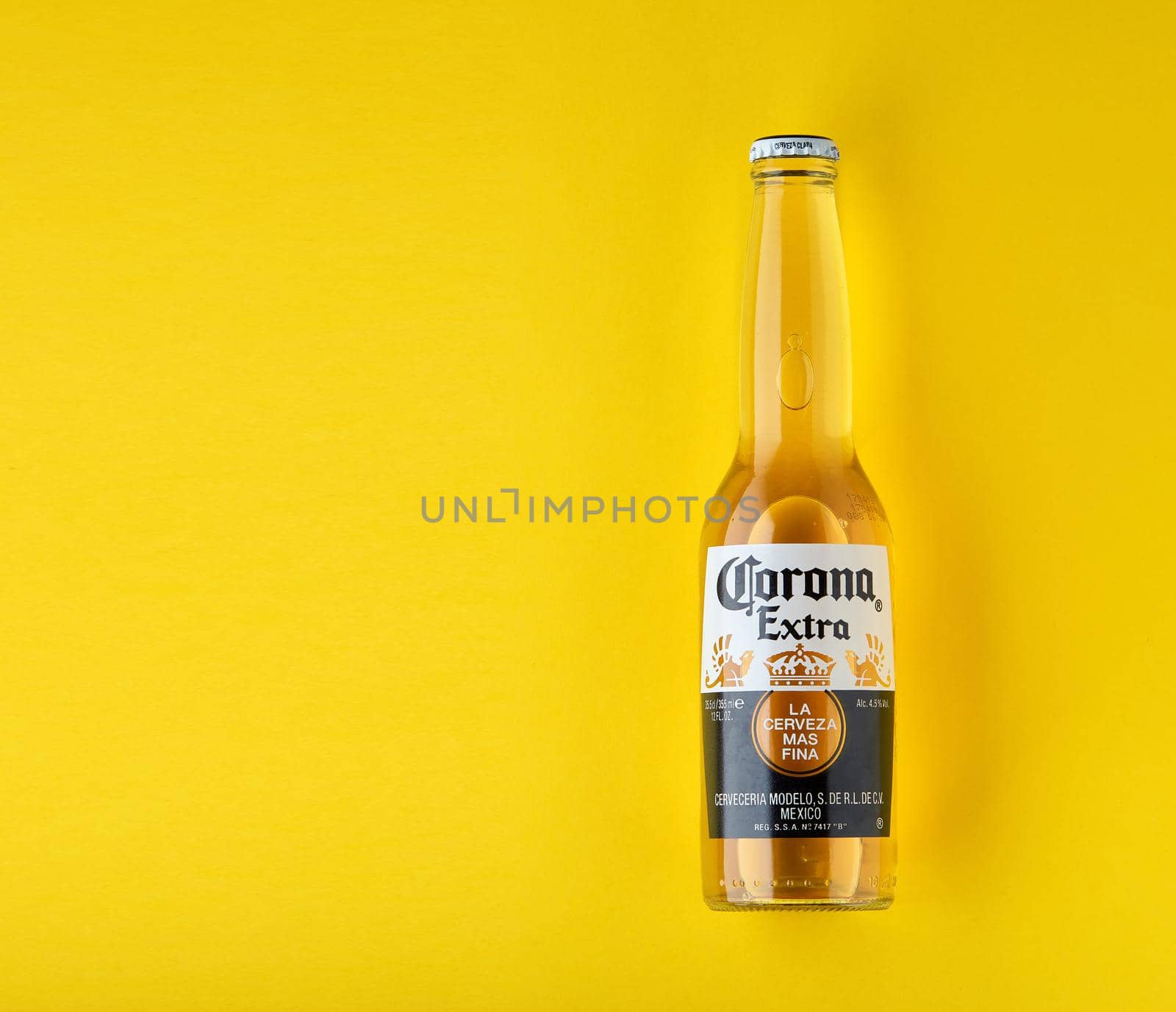 Bottle of Corona Extra Beer. On yellow background. Corona is made in Mexico and is the top selling imported beer in the United States. 13.03.2020, Russia.