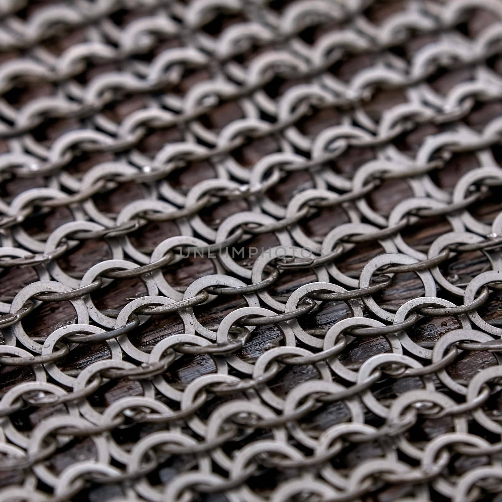 Chain-mail or Hauberk texture, metal protective armor of medieval or middle ages times. Hauberk medieval knight equipment shirt of ring mail