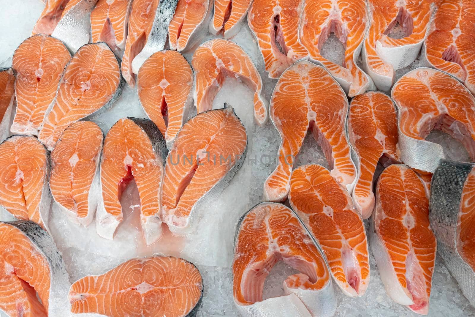 chunks of red fish in ice close-up. photo