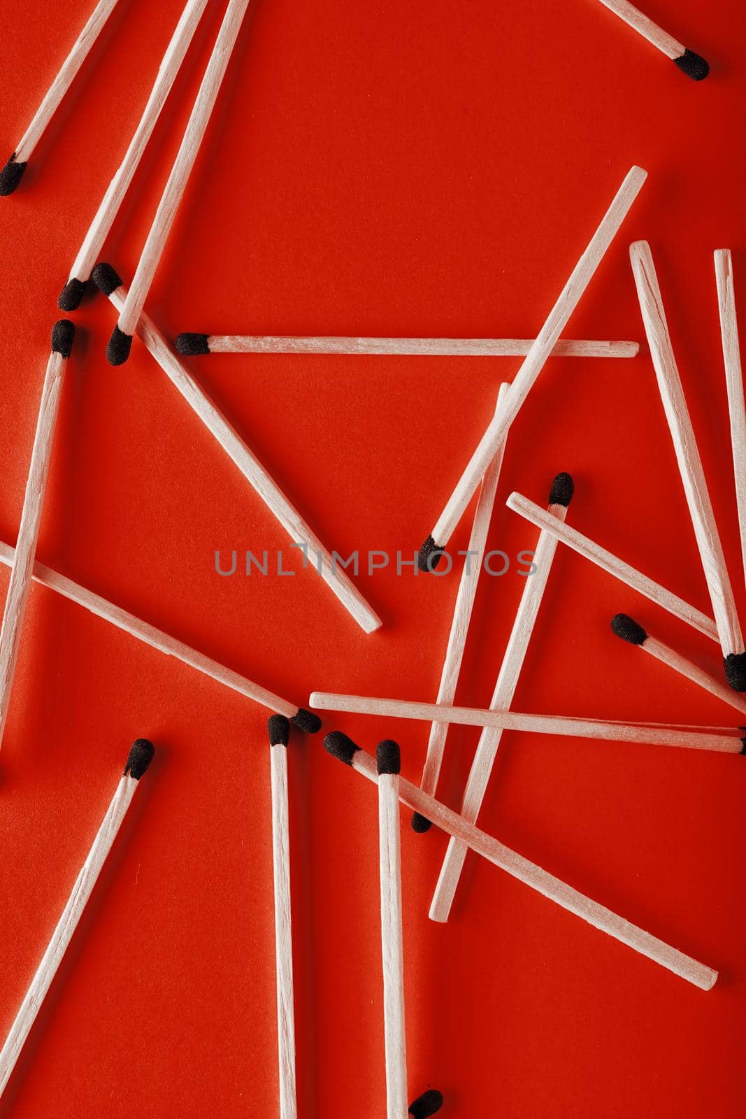 Matches on a red background, an abstraction about teamwork and modern relationships.