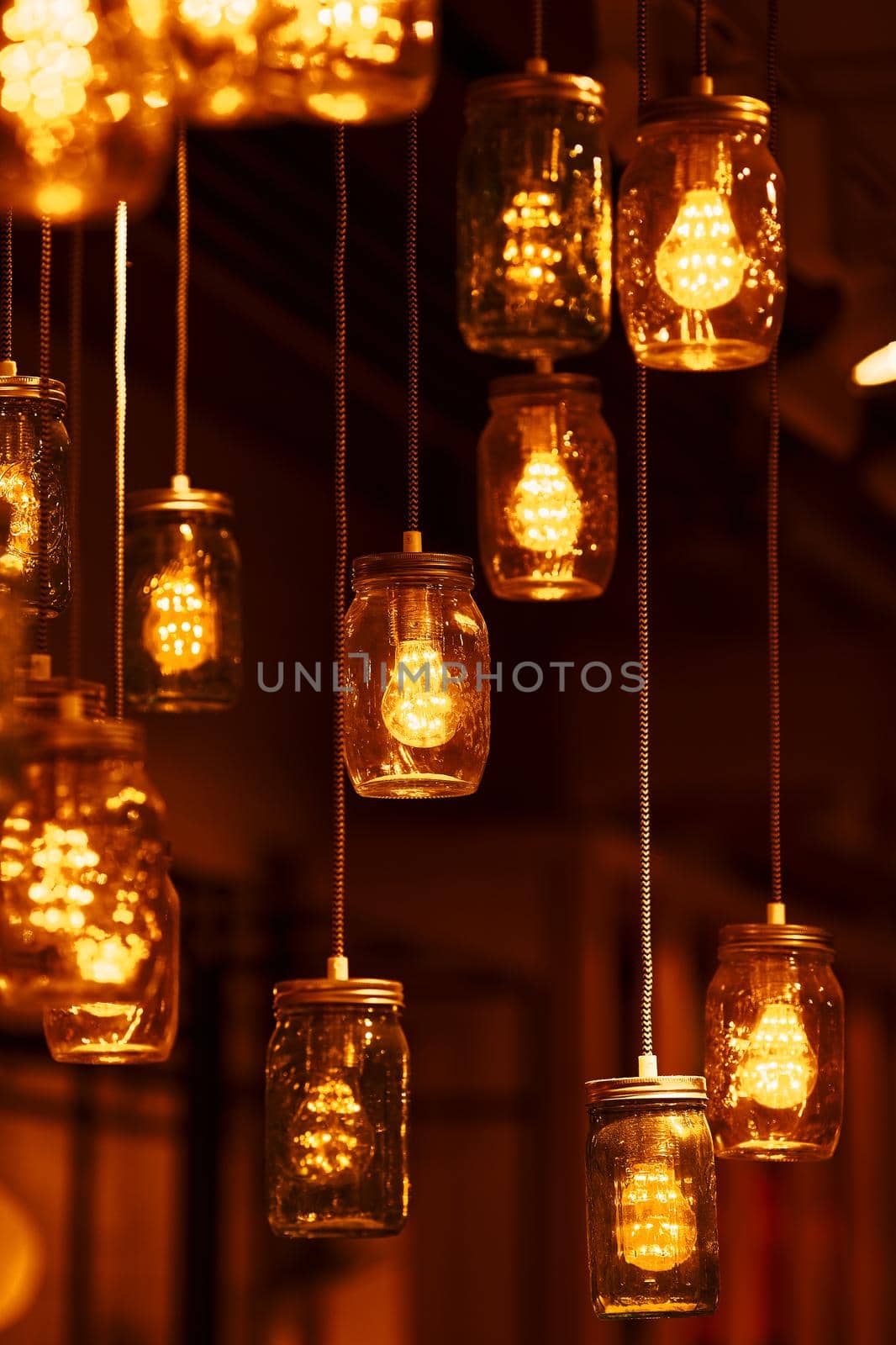 Light bulbs in glass jars. Cozy, warm atmosphere. Light Creative Decor