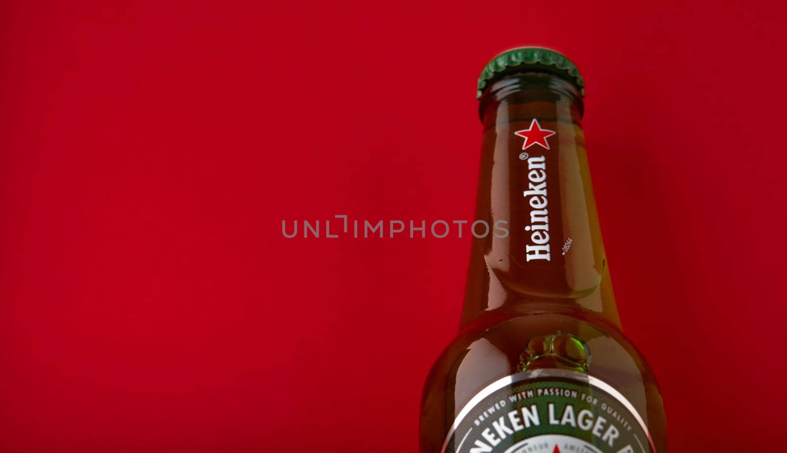 Bottle of Heineken Lager Beer on red background. Heineken is the flagship product of Heineken International. the world's most popular beer. 13.03.2020, Russia.