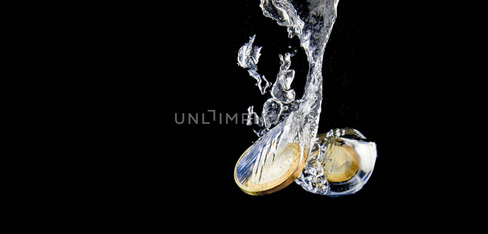 Sinking Euro. Splash of coins falling into the water. Coins in the water. Splash of coins falling into the water.