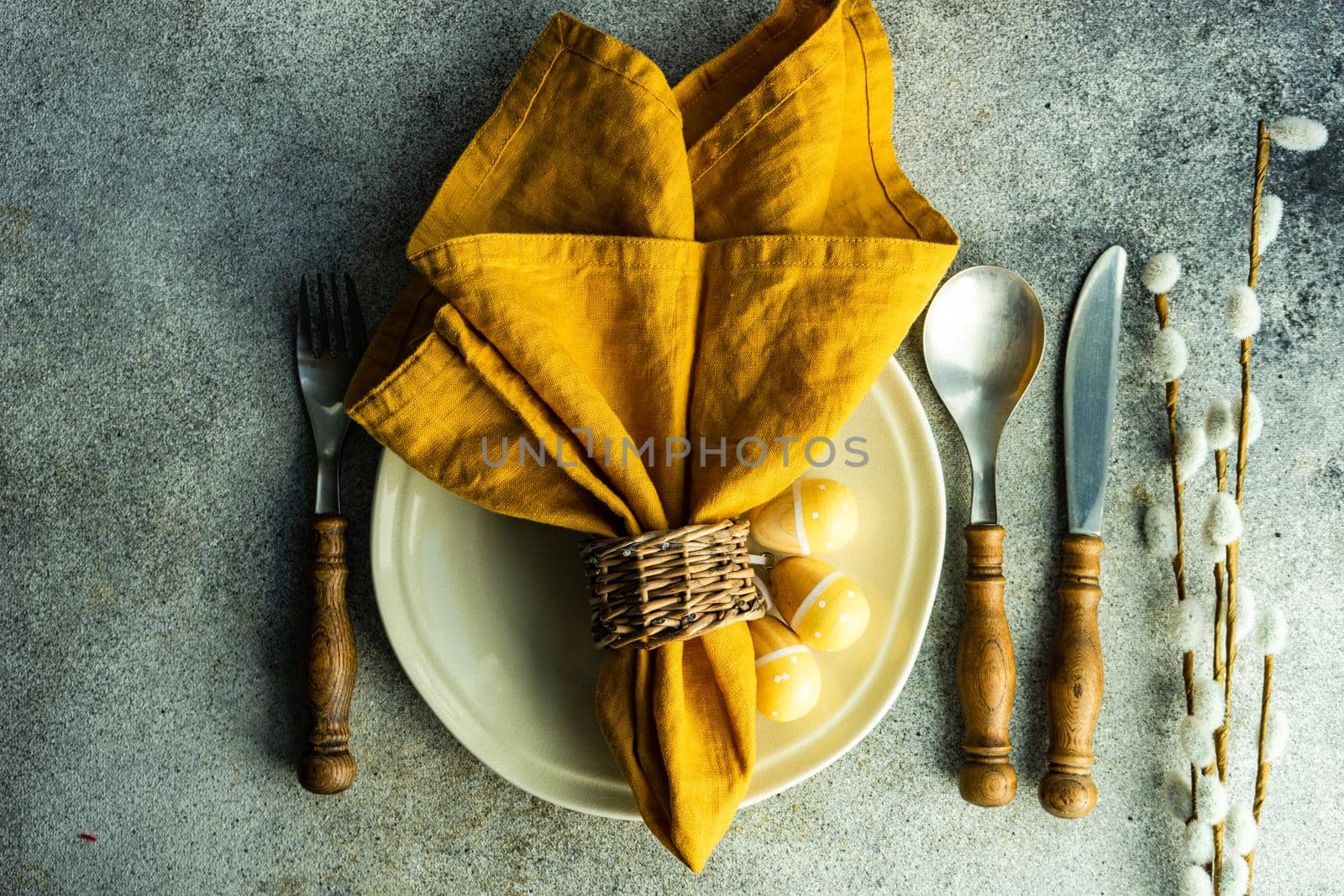 Easter dinner place setting on concrete background