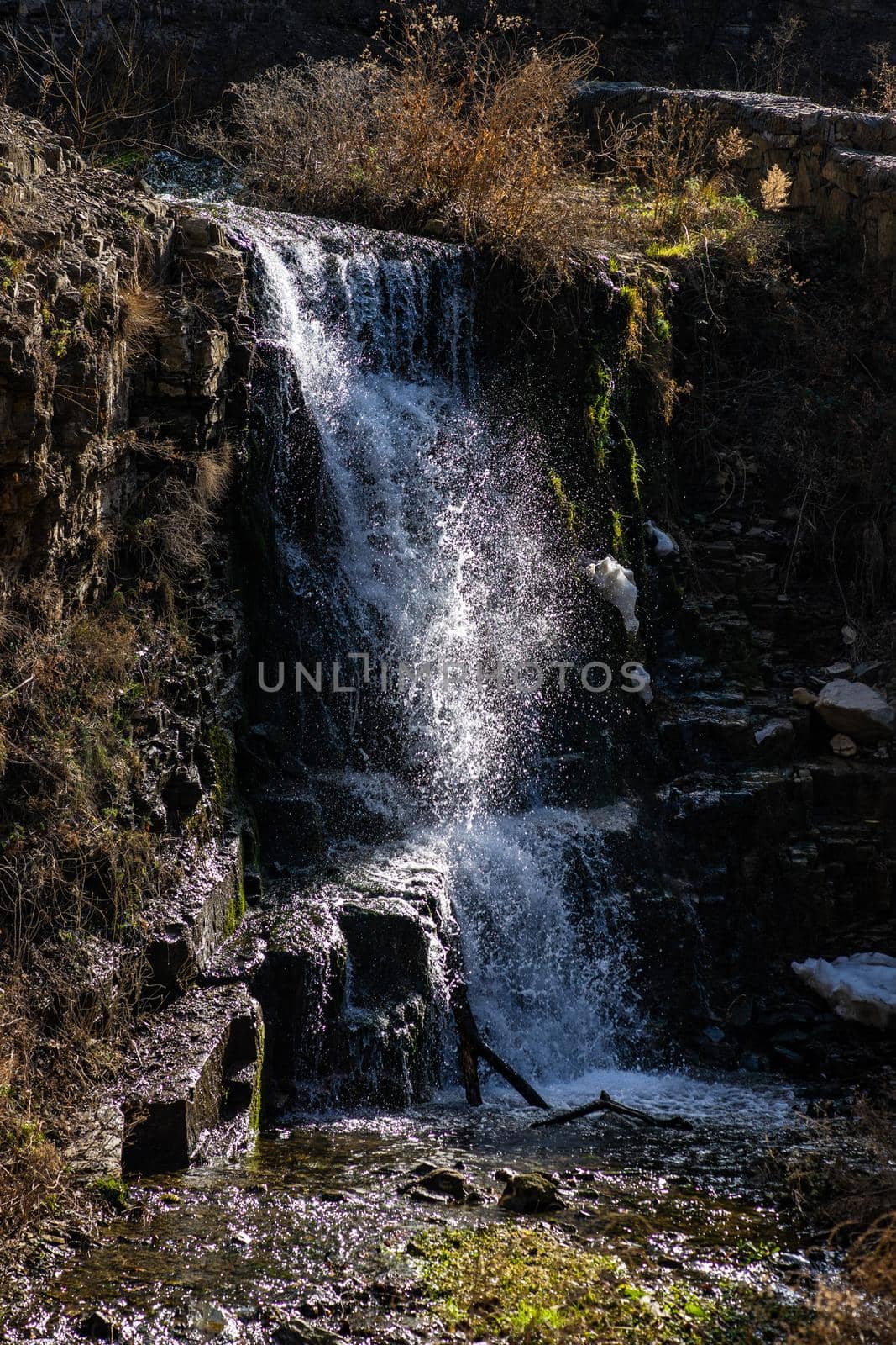 Waterfall in wild area close to georgian capital city Tbilisi in early sping season