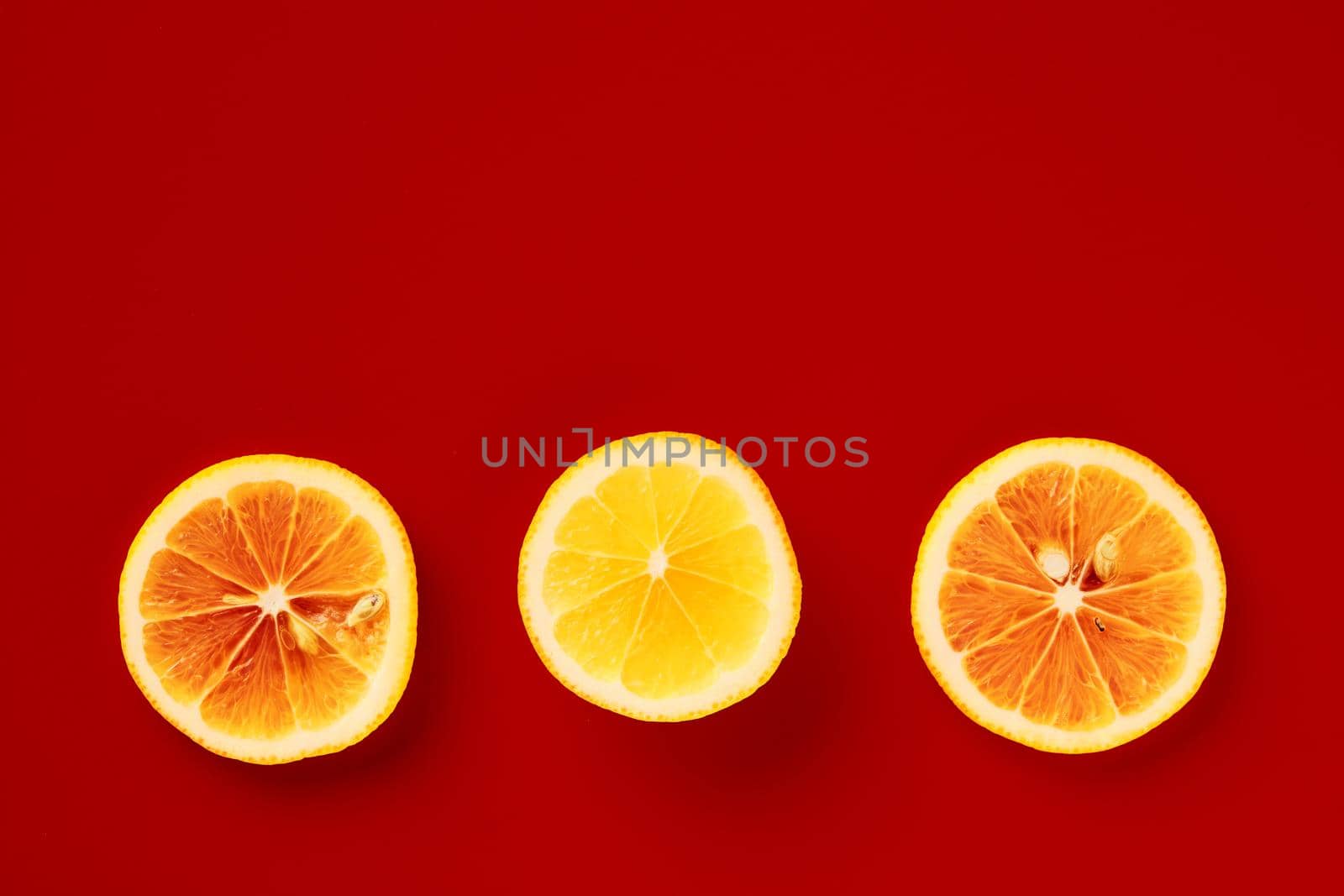 Bright yellow lemon on a red background.