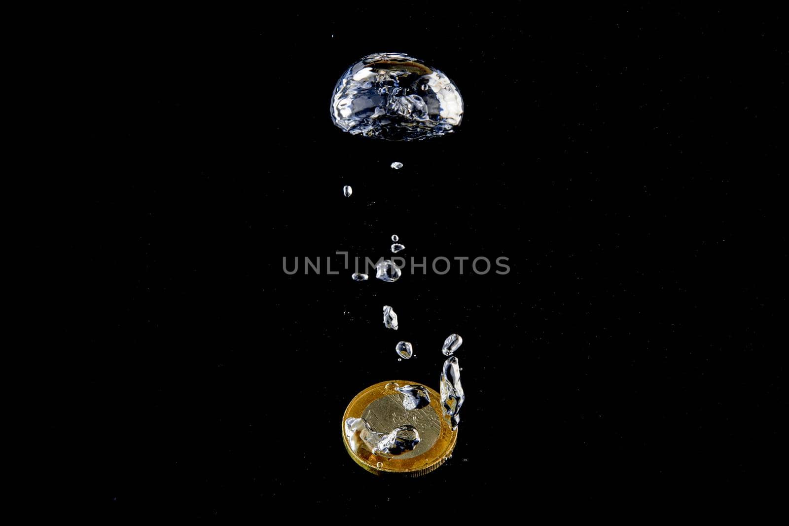 Sinking Euro. Splash of coins falling into the water. Coins in the water. Splash of coins falling into the water.