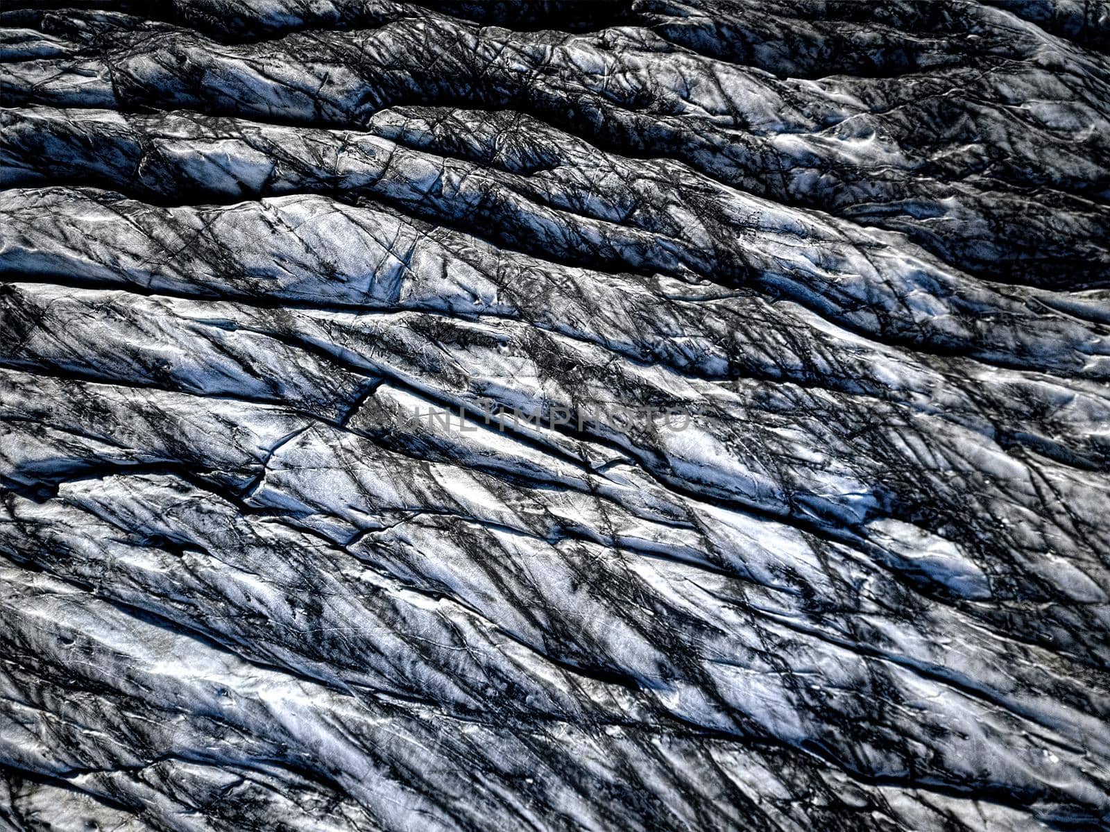 Aerial view of glacier from above, ice texture landscape, beautiful nature blue background from Iceland