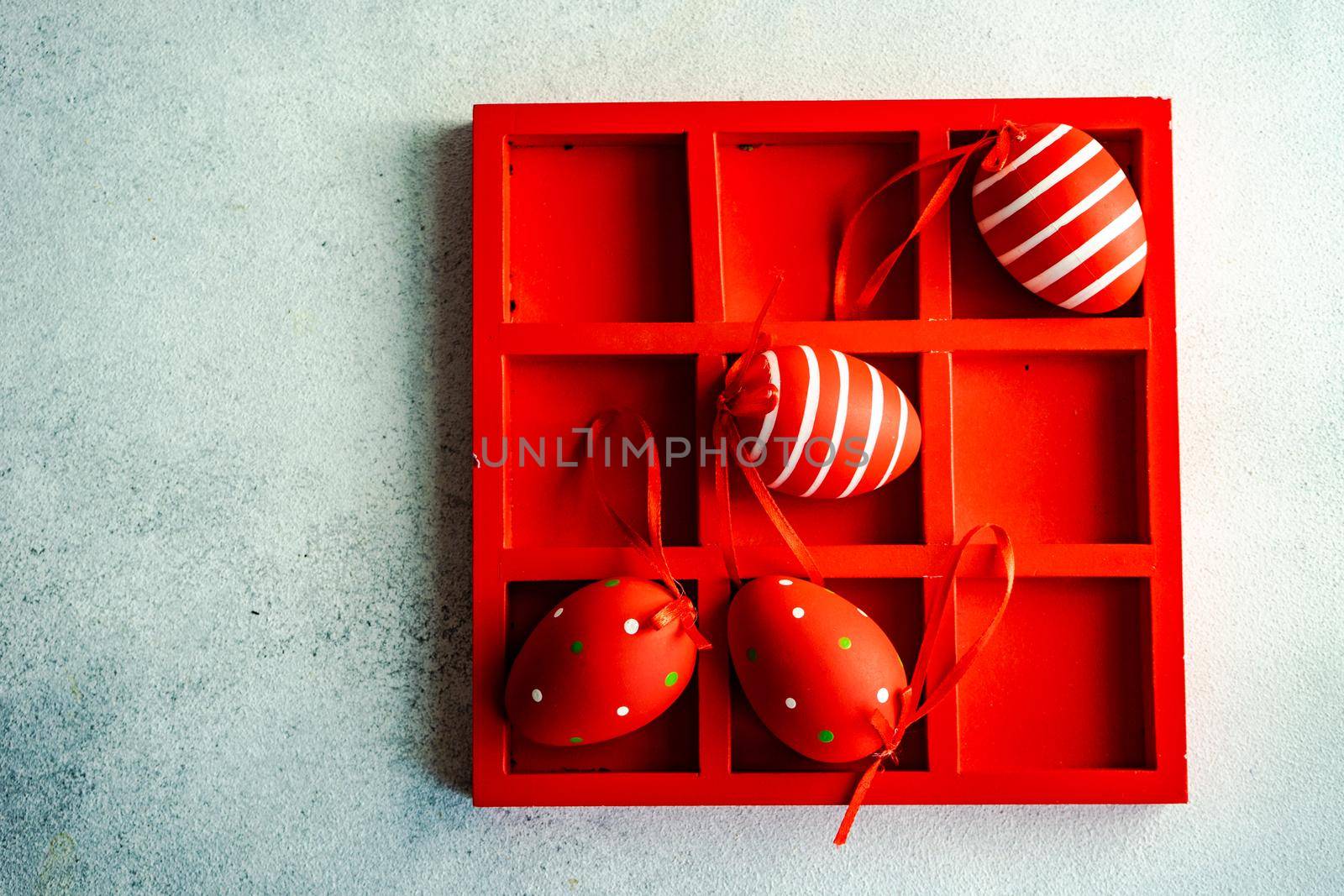 Red wooden box with 3x3 full of red Easter eggs