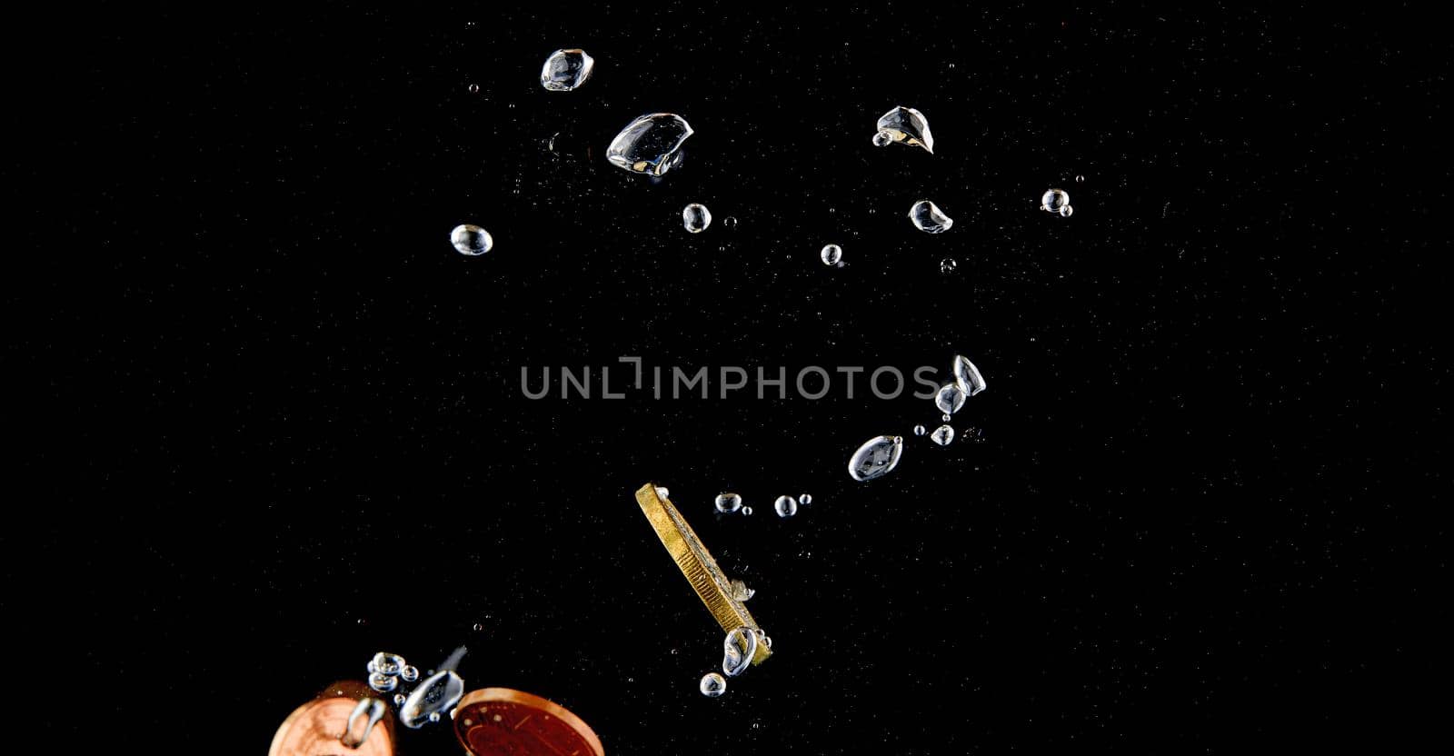 Sinking Euro. Splash of coins falling into the water. Coins in the water. Splash of coins falling into the water.