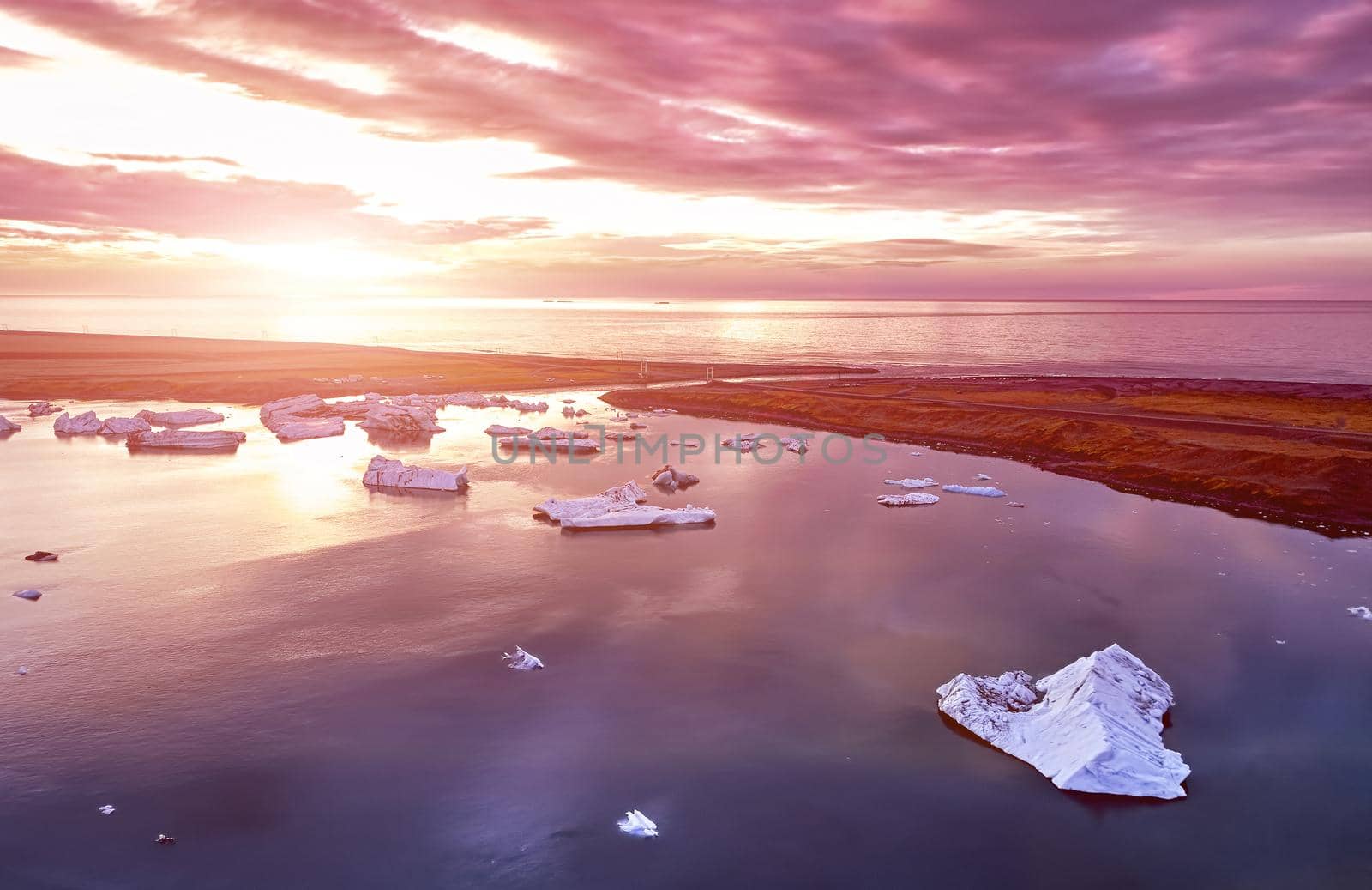 Aerial view of Glacier lagoon in Iceland during the sunrise. Ice floes calved from the glacier. melting ice