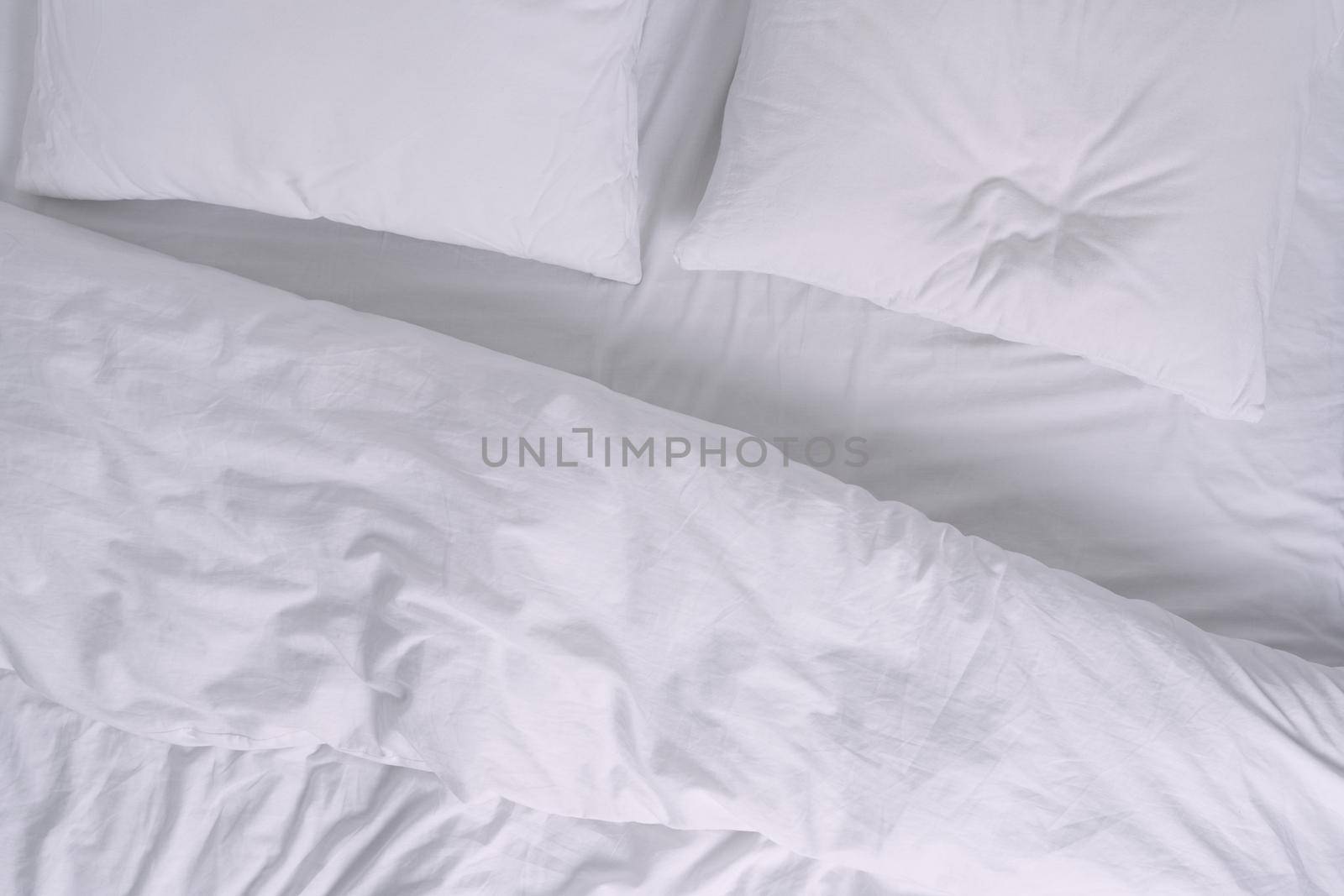 Top view of white bed with pillows. High quality photo