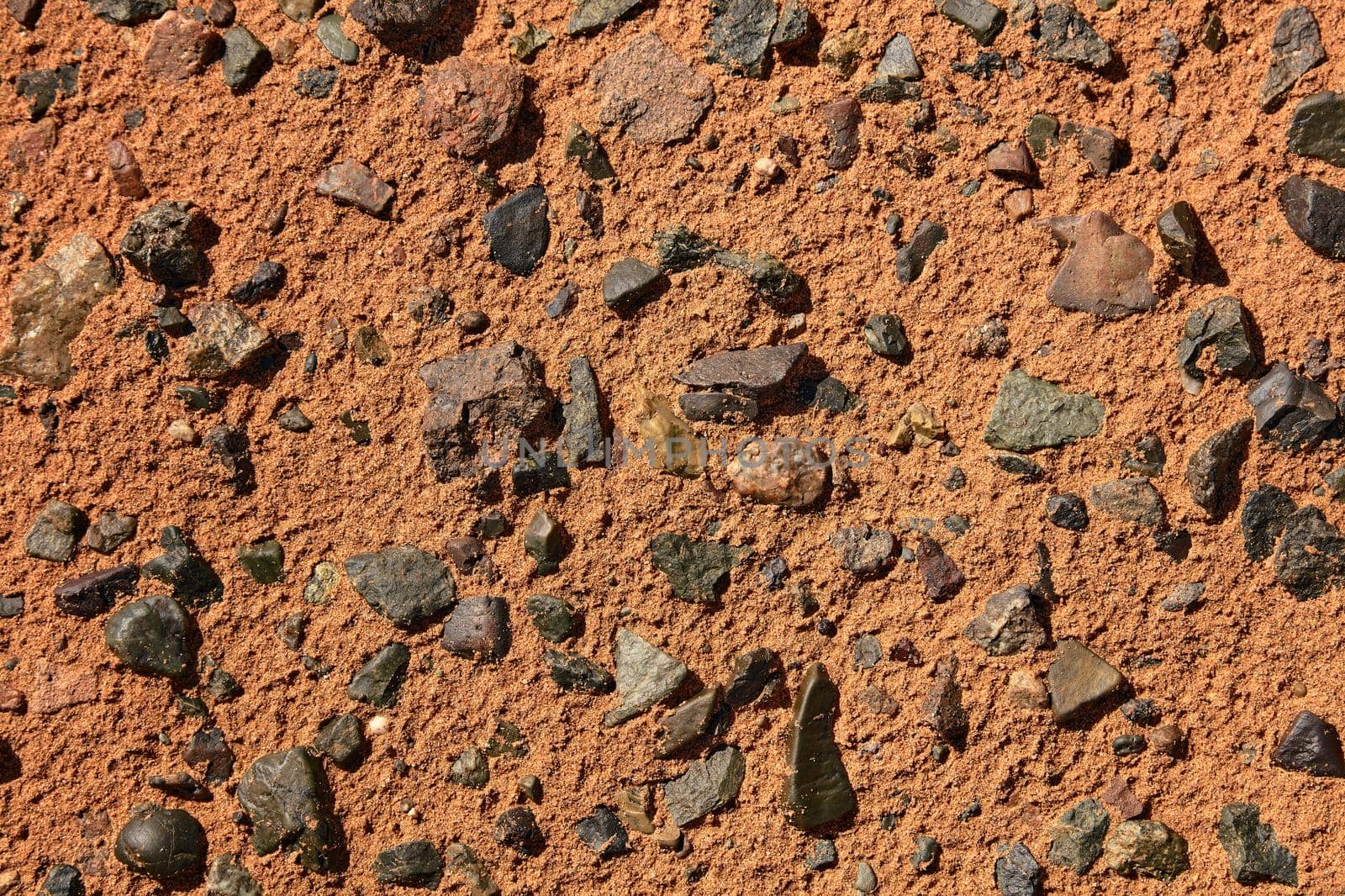 Black Gobi. Stony desert, black stones on the sand. Abstract natural background. by EvgeniyQW