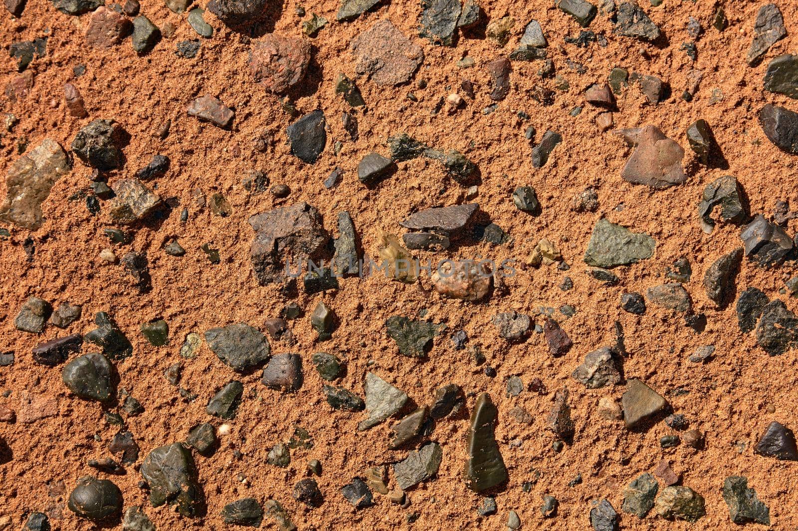 Black Gobi. Stony desert, black stones on the sand. Abstract natural background.