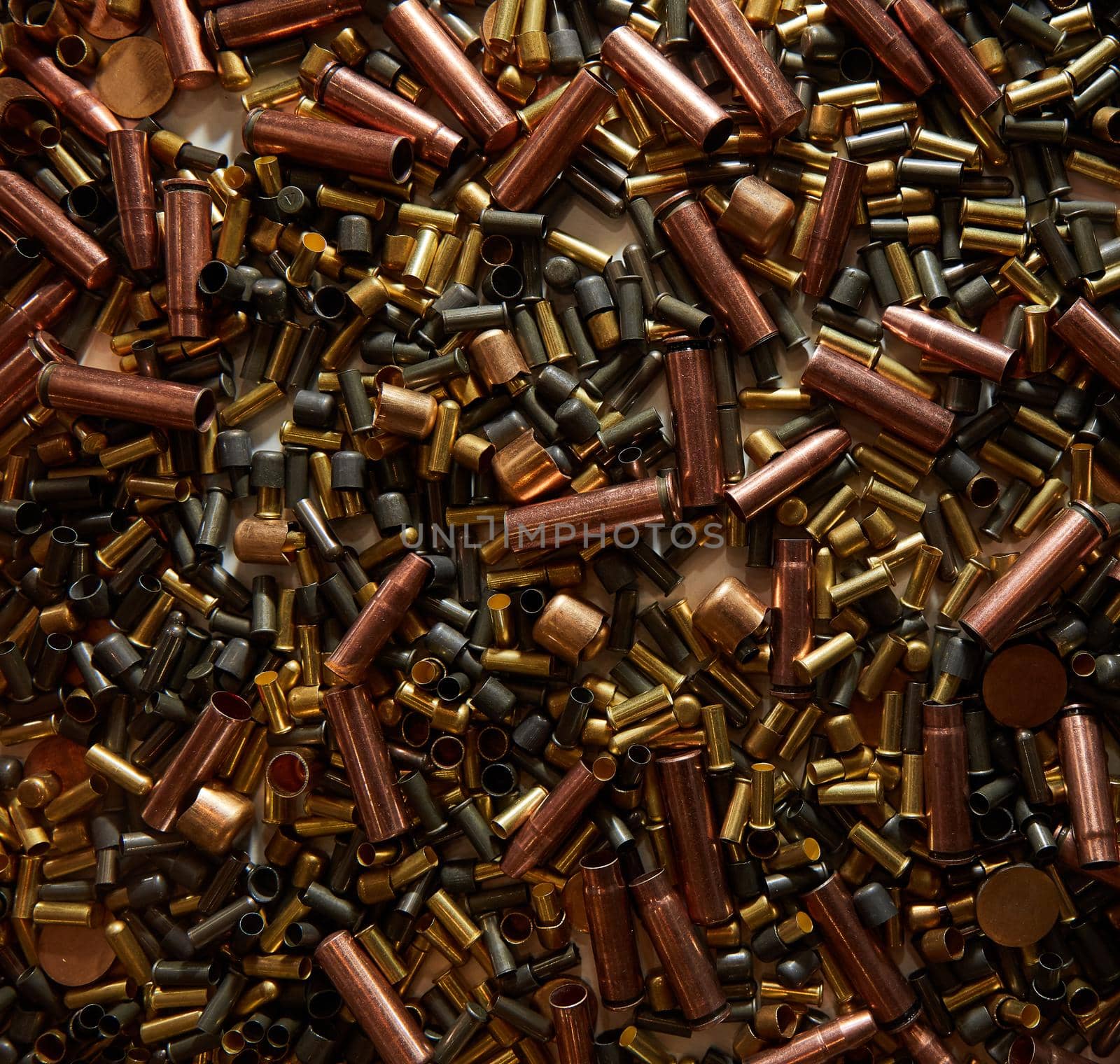 Different size bullet shells on the black ground. War concept. production of ammunition at the factory. brass bullet shell, ammunition manufacturing process by EvgeniyQW