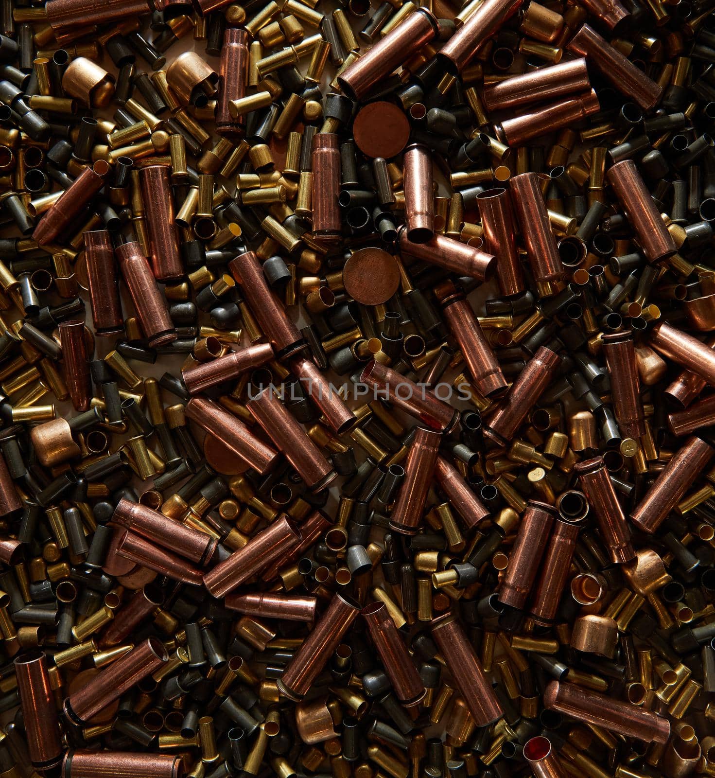 Different size bullet shells on the black ground. War concept. production of ammunition at the factory. brass bullet shell, ammunition manufacturing process