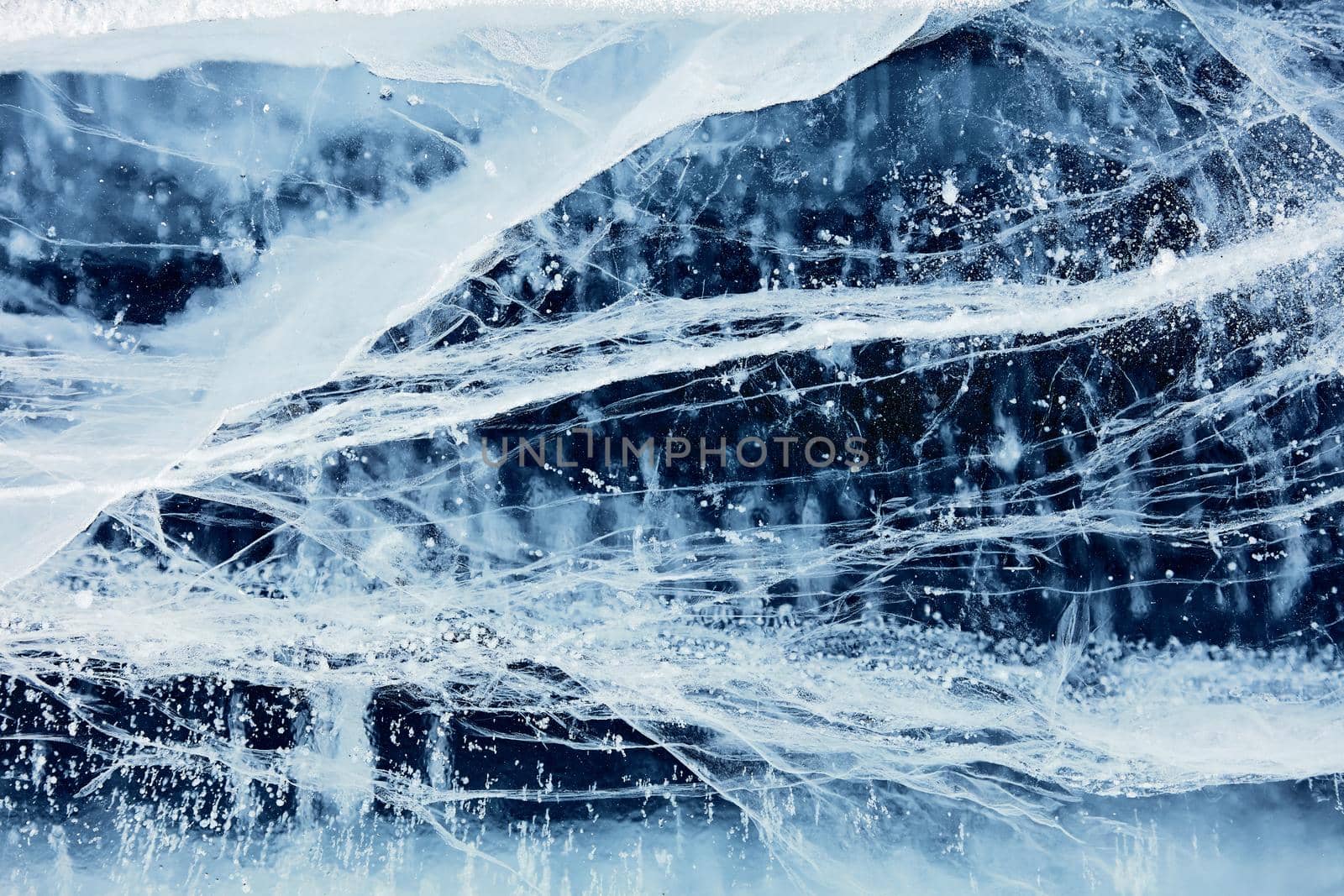 Texture of ice of Baikal lake in Siberia. blue lake ice.