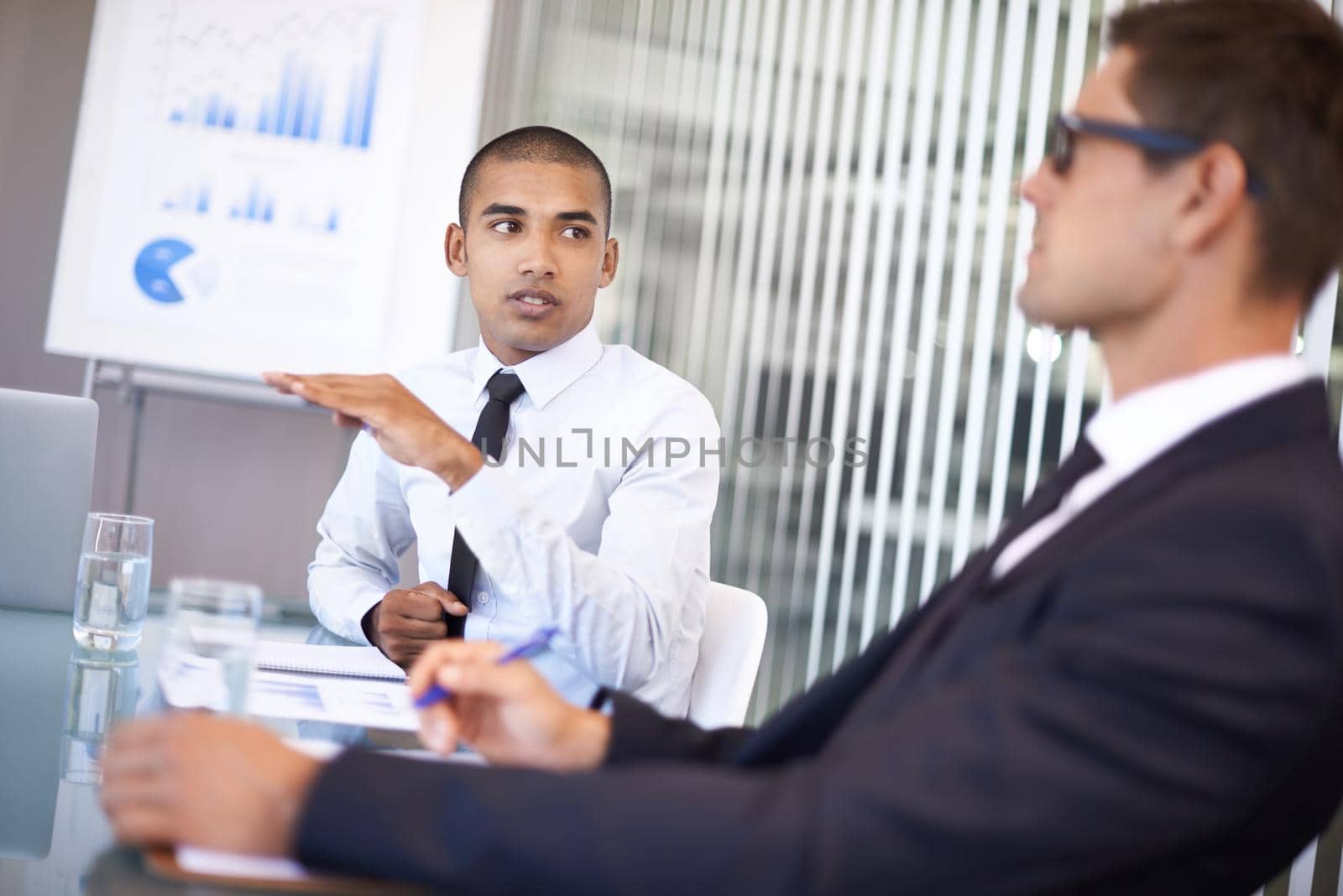 Shot of a businessman explaining a concept to his colleague during a meeting.