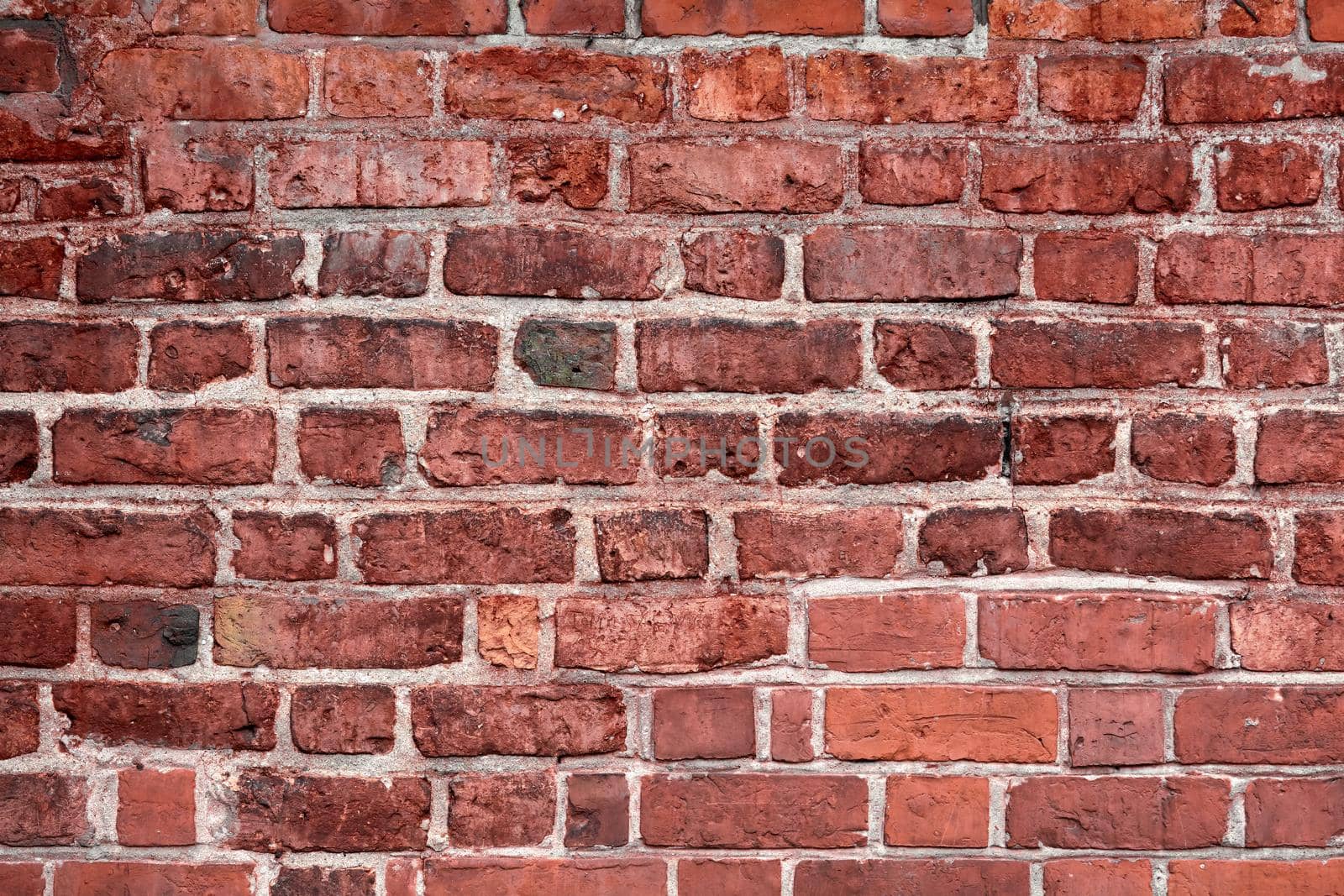 Old brick wall. Horizontal wide red color brick wall background. Vintage house facade
