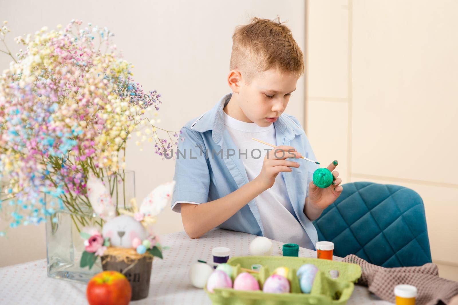 Big Happy Family preparing for Easter. Cute child boy painting egg. Home activity. Concept of unity and love.