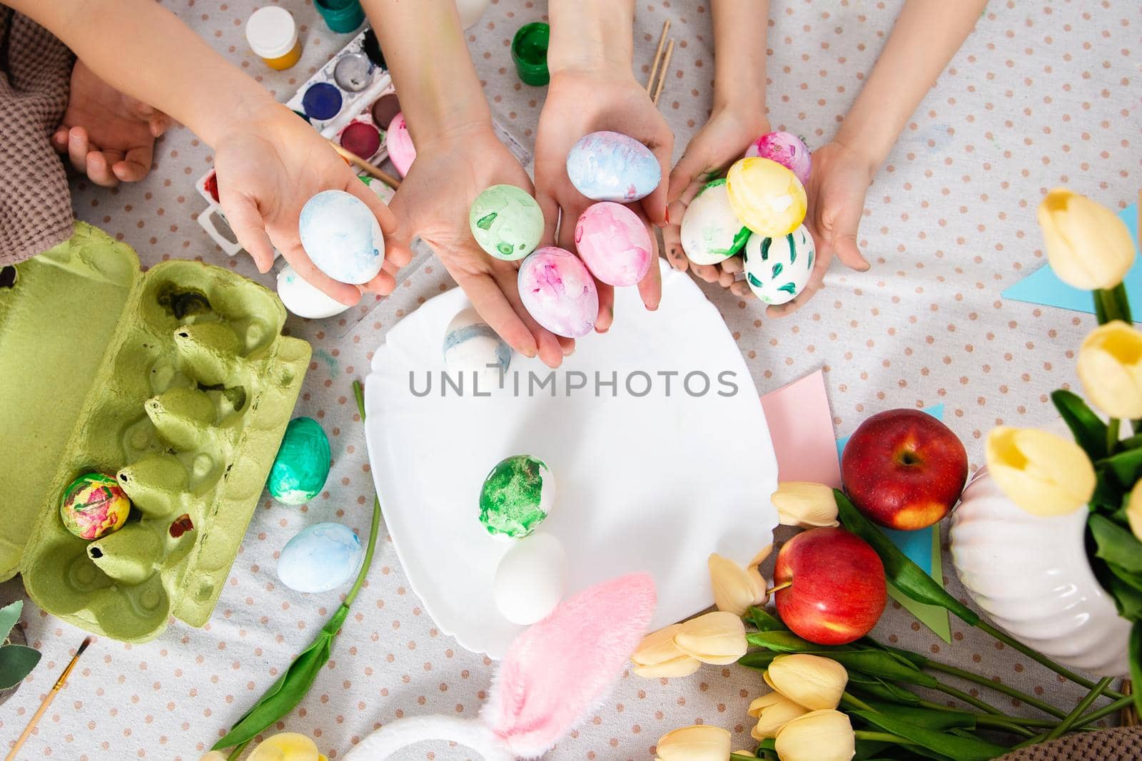 Happy Family preparing for Easter. Top view. Home activity. Concept of unity and love. Mom and sons. Brothers by Marina-A