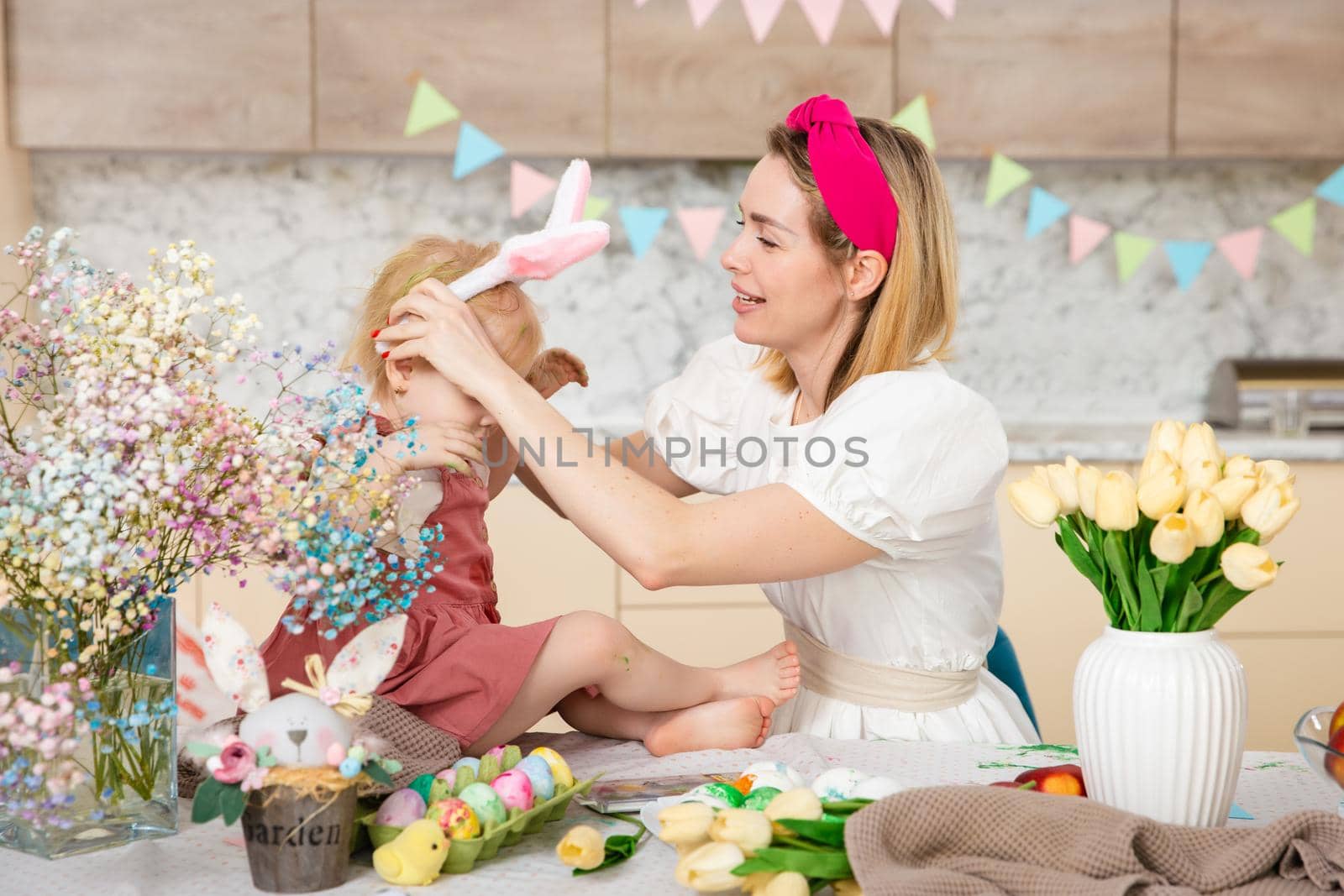 Happy Family preparing for Easter. Cute girl with mother. Home activity. Concept of unity and love. Mom and daughter by Marina-A