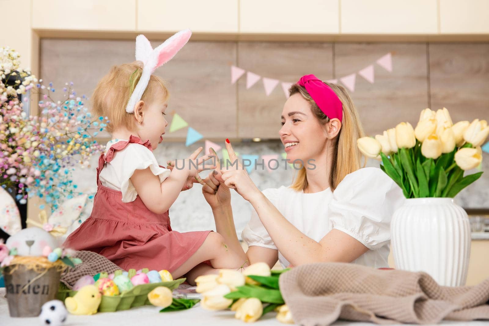 Happy Family preparing for Easter. Cute girl plaing with mother. Home activity. Concept of unity and love. Mom and daughter by Marina-A