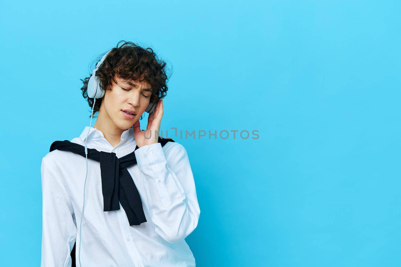 teenager in headphones listening to music isolated backgrounds by SHOTPRIME