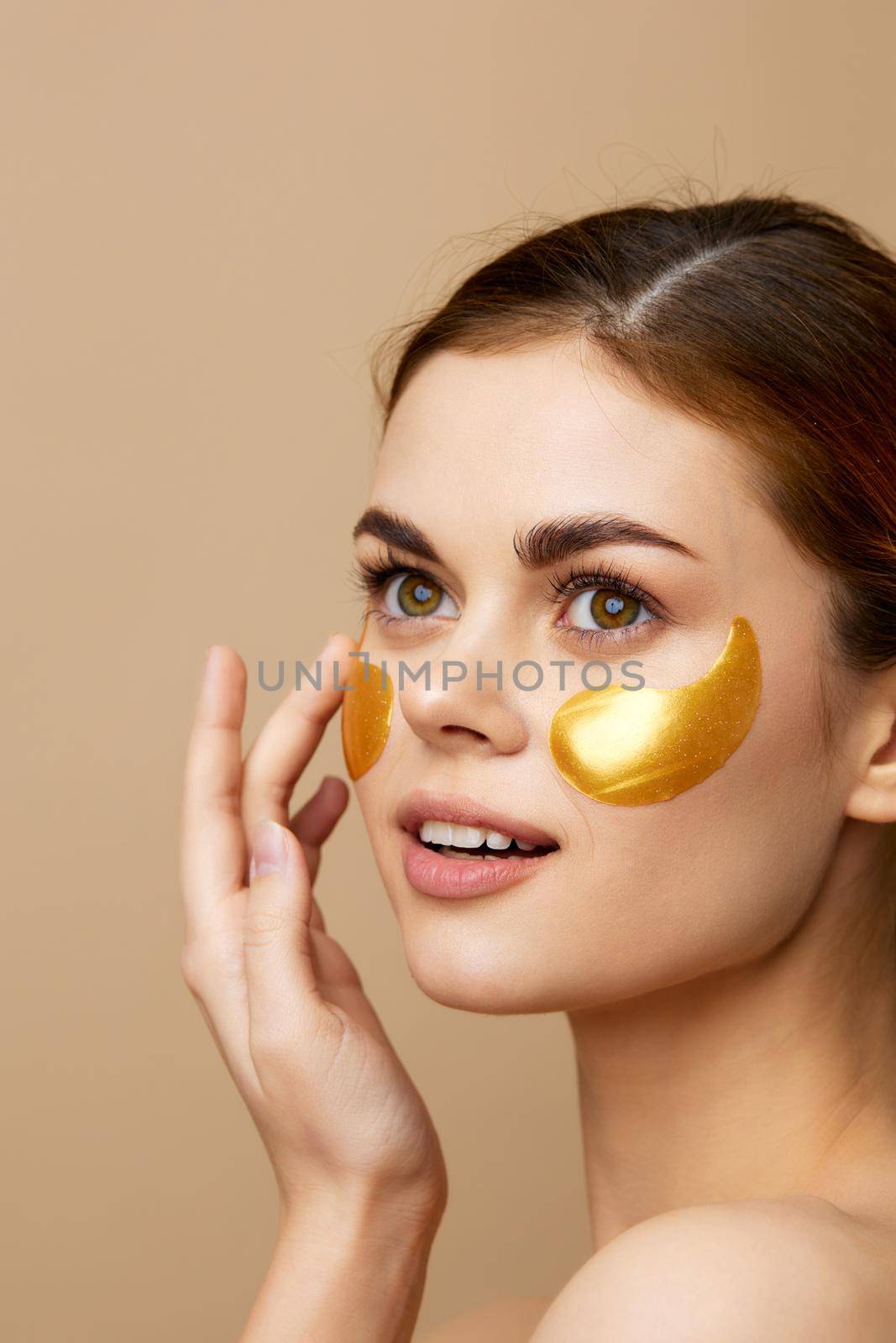 pretty woman golden patches on the face isolated background. High quality photo