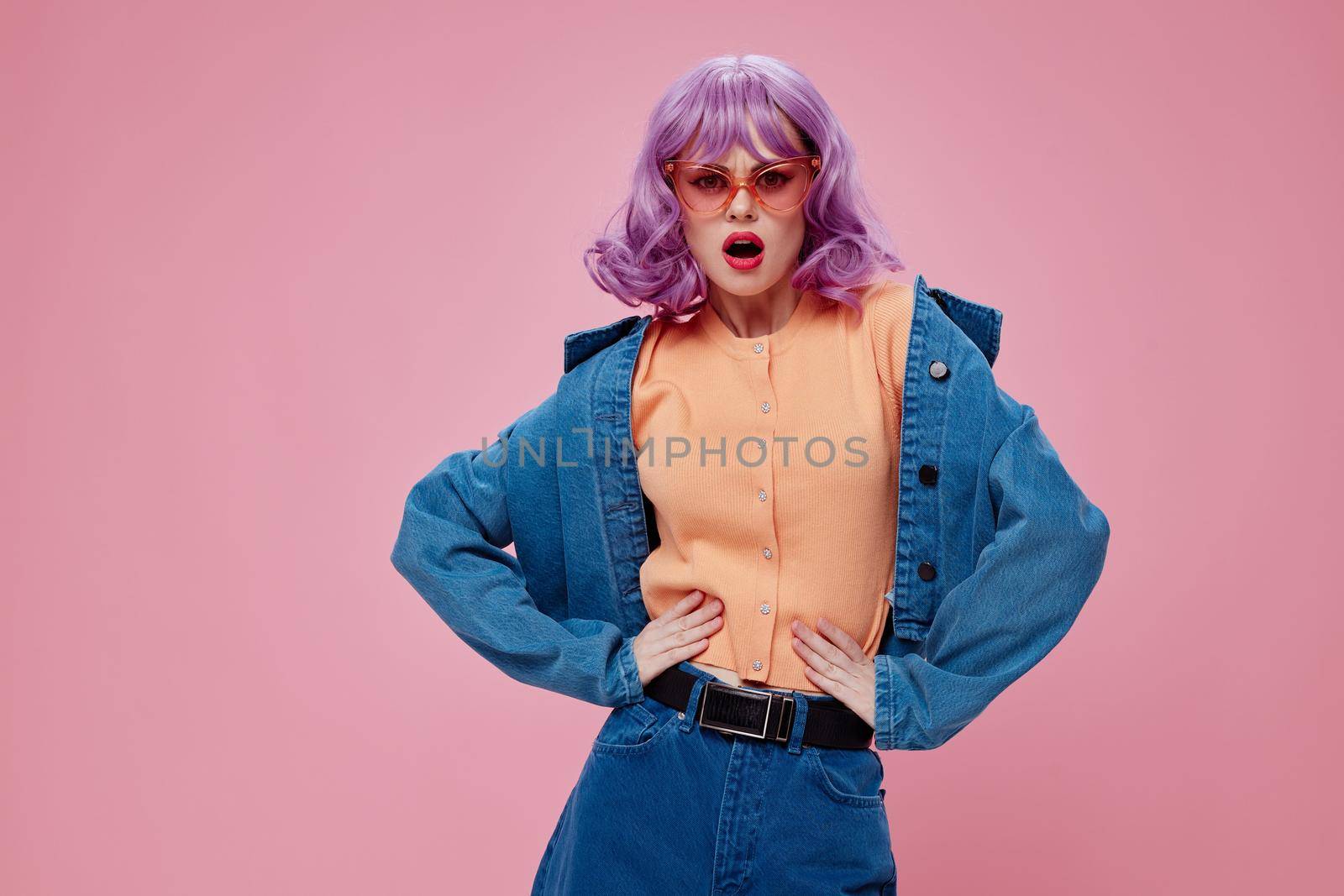 Portrait of a charming lady denim clothing fashion posing cap pink glasses pink background unaltered by SHOTPRIME