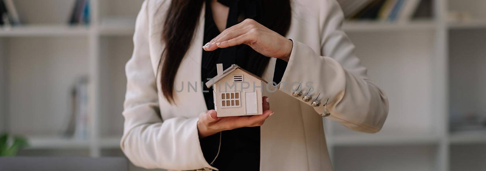 House covered of woman hands - insurance real estate concept. by nateemee