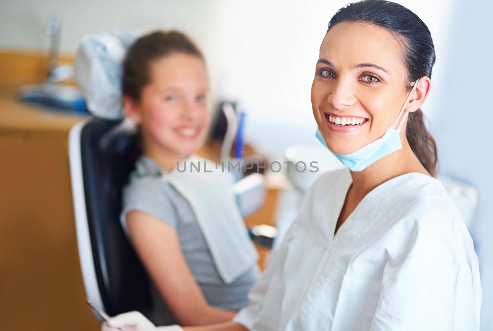 Portrait of a female dentist and child in a dentist office.