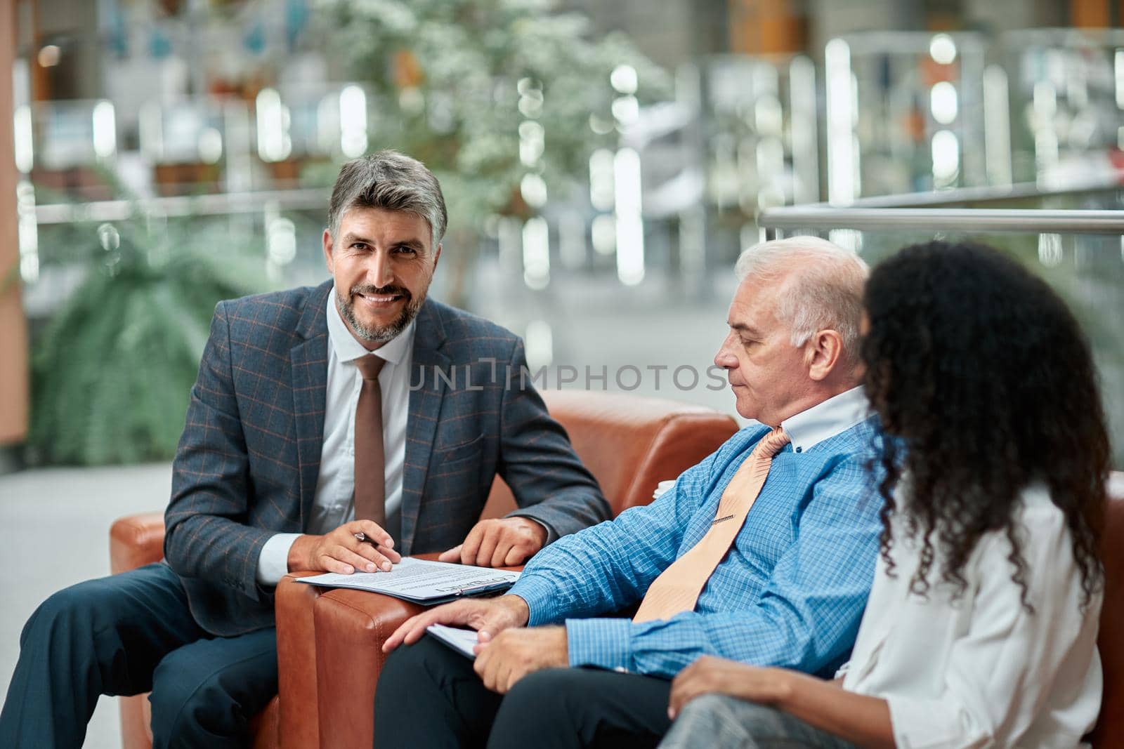 satisfied businessman shaking hands with his business partner. by SmartPhotoLab