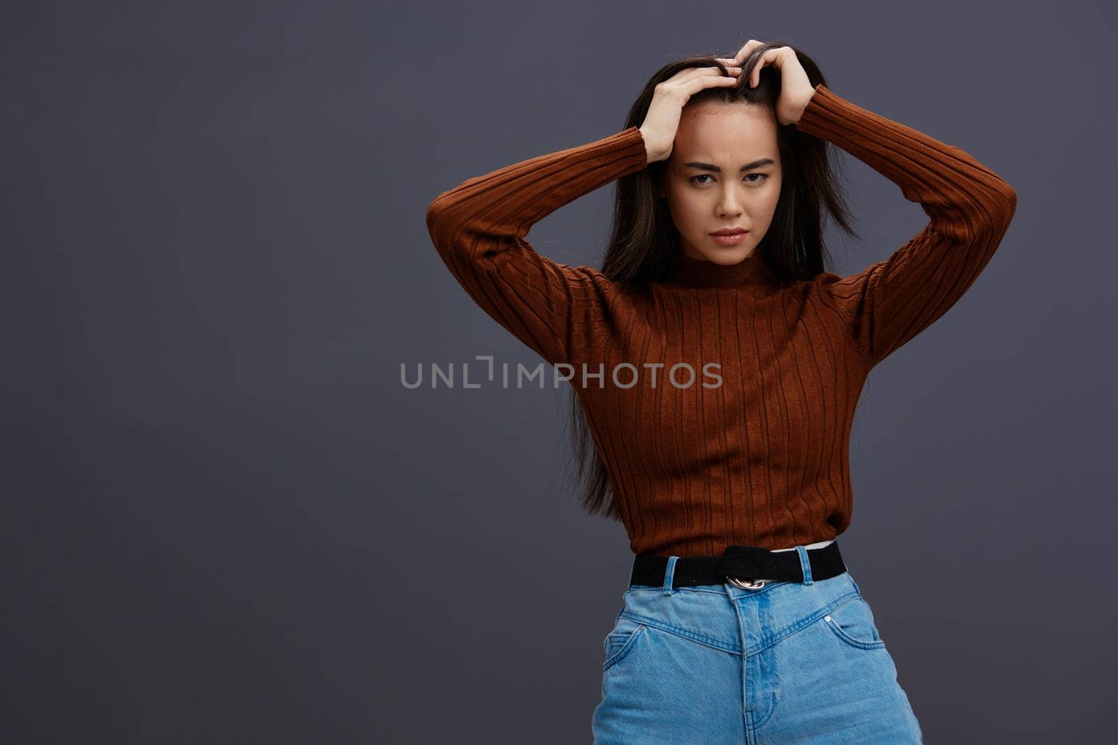 Brunette hand gestures brown sweater fashion emotions isolated background by SHOTPRIME