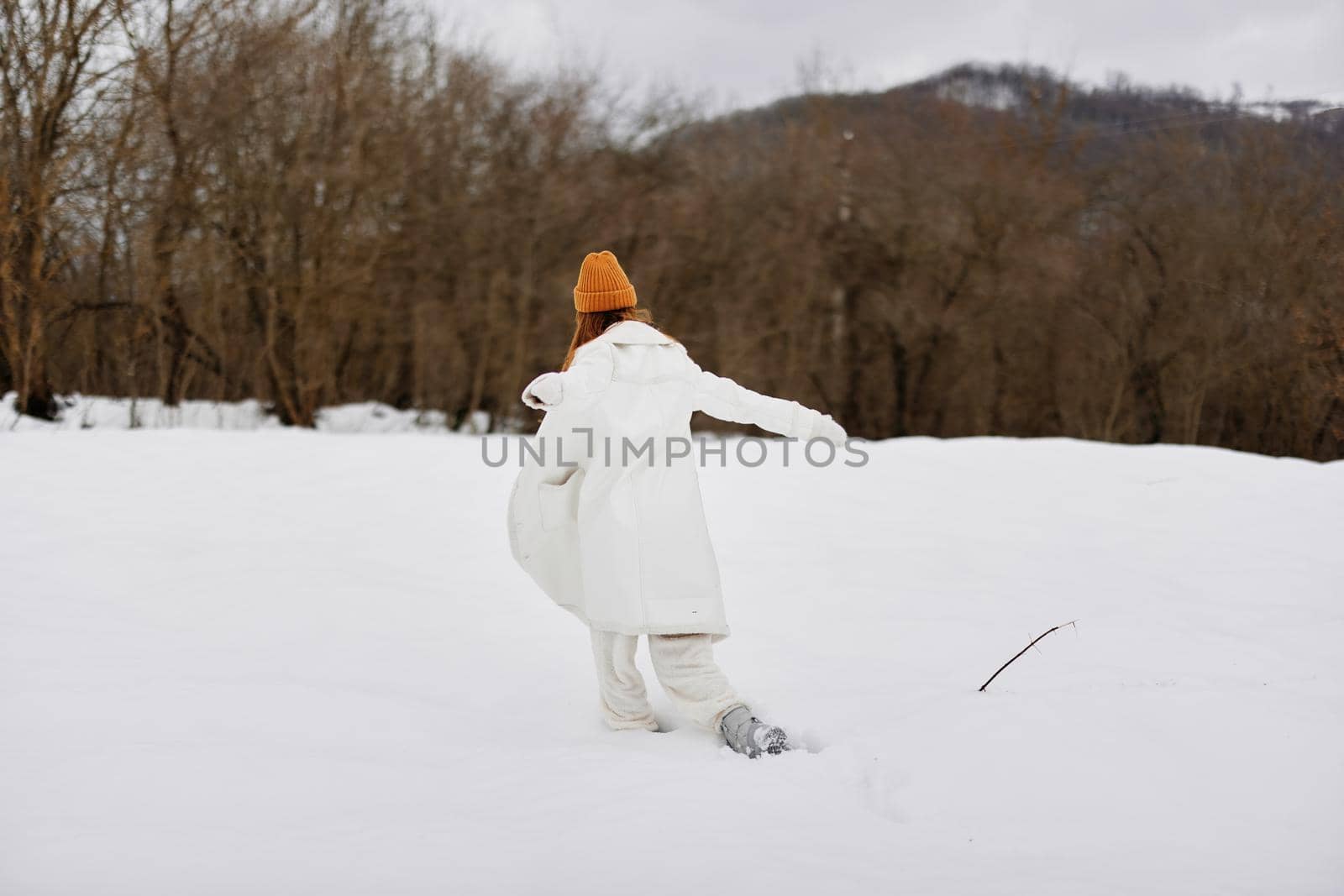 Happy young woman walk in the snow fun nature landscape There is a lot of snow around by SHOTPRIME