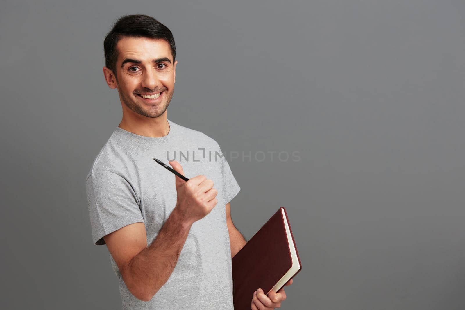 portrait man in gray t-shirts posing lifestyle casual wear Gray background. High quality photo