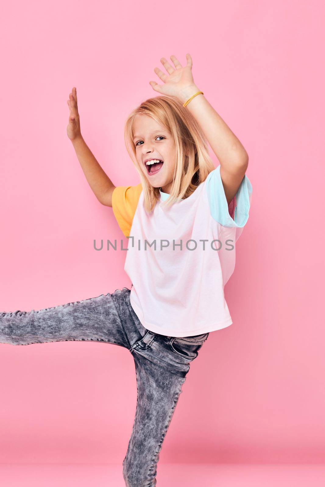 joyful girl dancing gesture with hands pink background. High quality photo