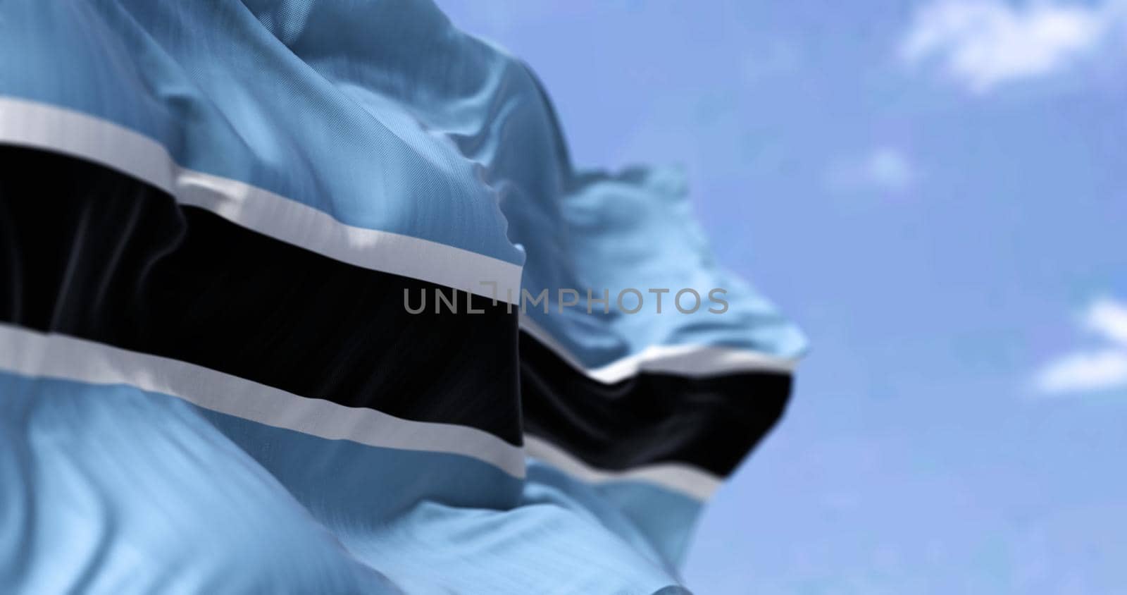 Detail of the national flag of Botswana waving in the wind on a clear day. Democracy and politics. Patriotism. Selective focus. Botswana is a landlocked country in Southern Africa