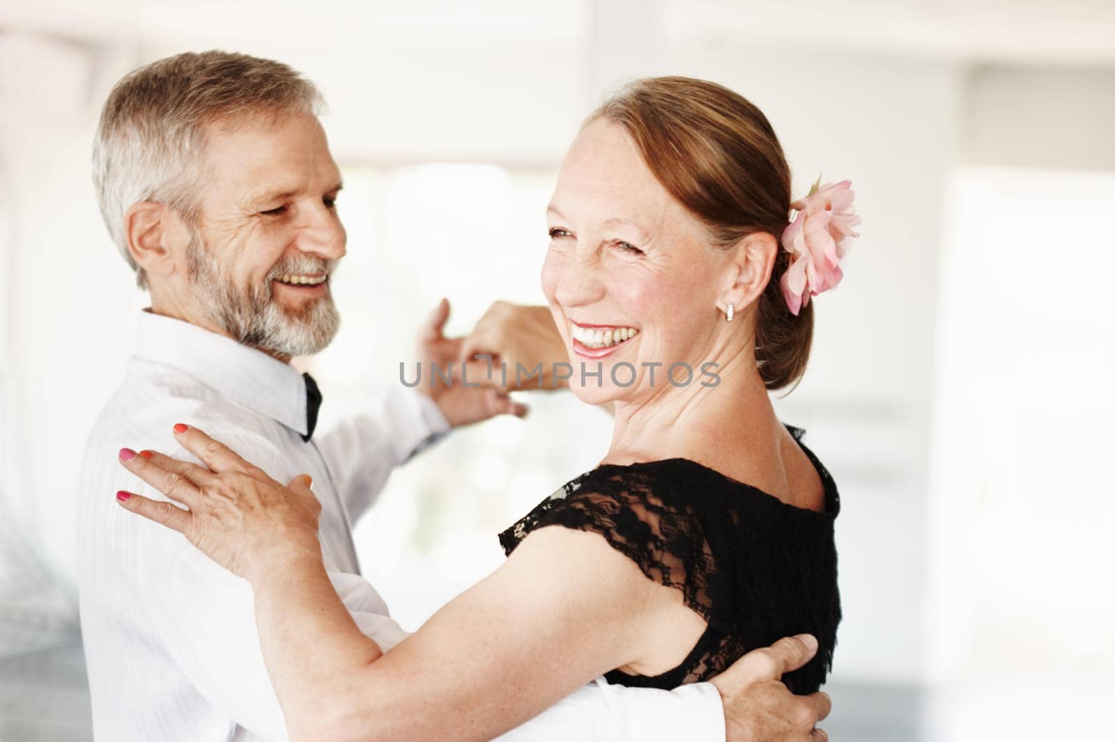 Shot of a mature couple dancing together in formal attire.
