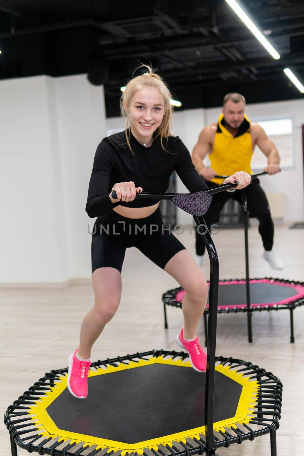 Women's and men's group on a sports trampoline, fitness training, healthy life - a concept trampoline group batut girl men, In the afternoon lifestyle team in training from young shaping, shape beautiful. Legs happy loss, class by 89167702191
